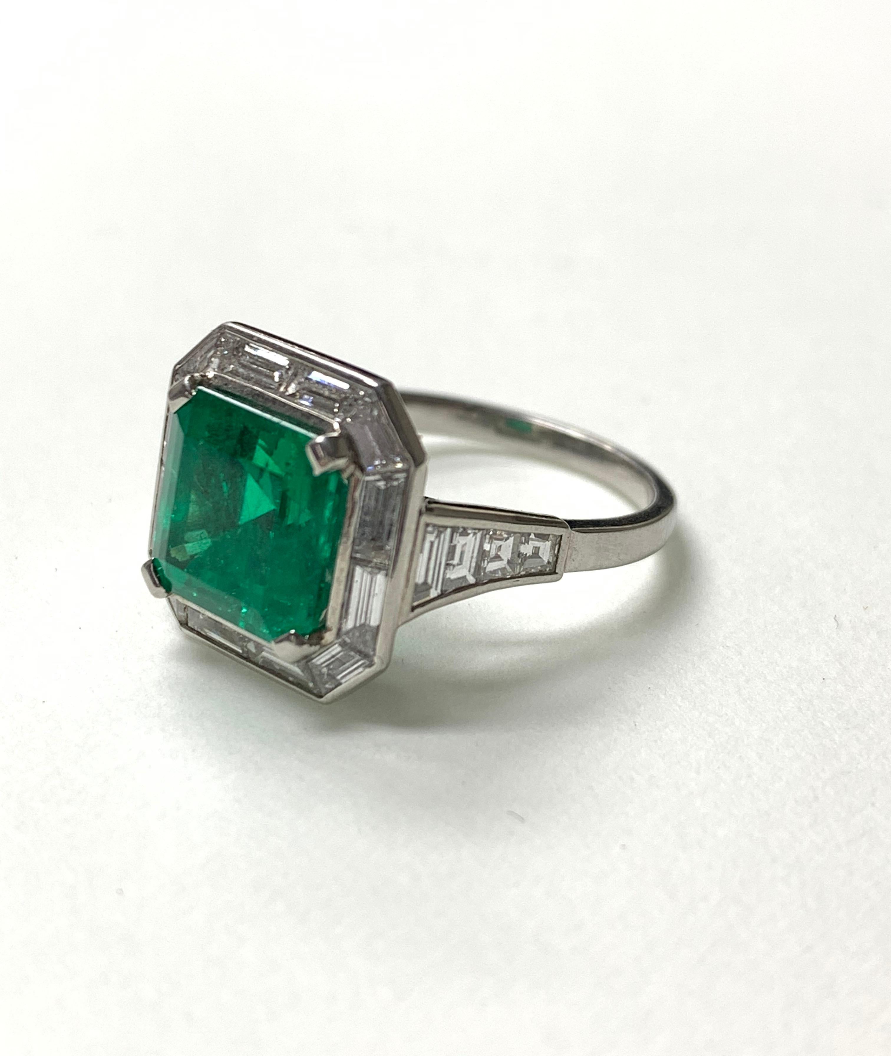 One of a kind emerald and diamond ring is handcrafted in platinum. 
Emerald weight : 3.87 carat 
Diamond weight : 1.71 carat ( GH color and VS clarity ) 
Metal : Platinum 
Ring Size : 6 1/4 