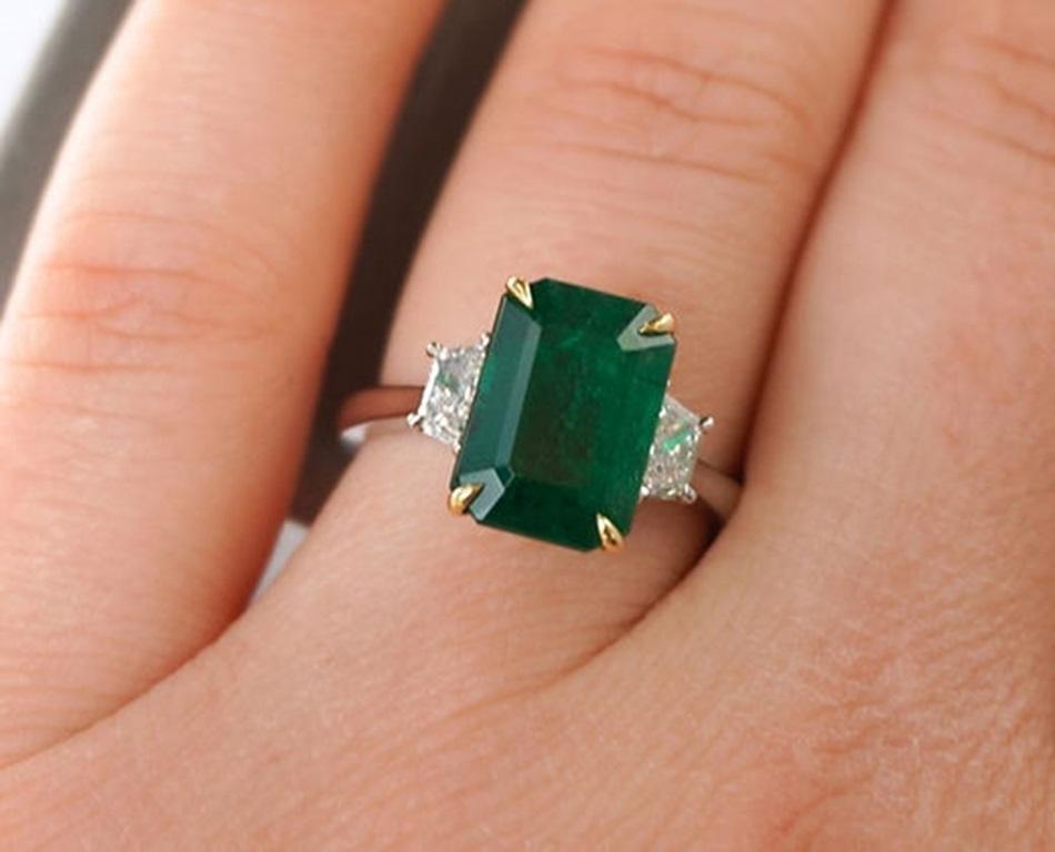Emerald Weight: 3.87 ct, Diamond Weight: 0.42 ct F-VS, Metal: Platinum, Metal Weight: 5.94 gm, Ring Size: 6, Shape: Emerald-Cut, Color: Vivid Green, Hardness: 7.5-8, Birthstone: May, Origin: Zambia
