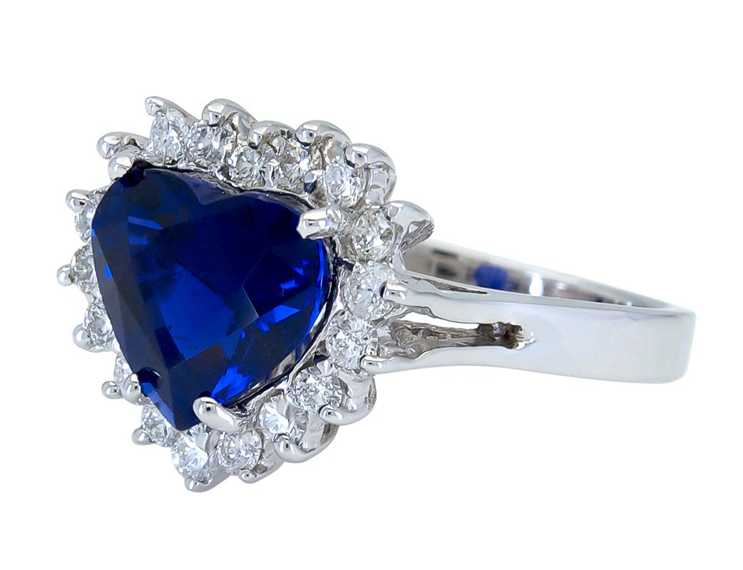Ein schicker Verlobungsring mit einem farbenprächtigen, herzförmigen blauen Saphir, eingefasst in einen dreizackigen Diamantenhalo. Hergestellt aus 18 Karat Weißgold.
Der blaue Saphir wiegt 3,87 Karat.
Die Diamanten wiegen insgesamt 0.64