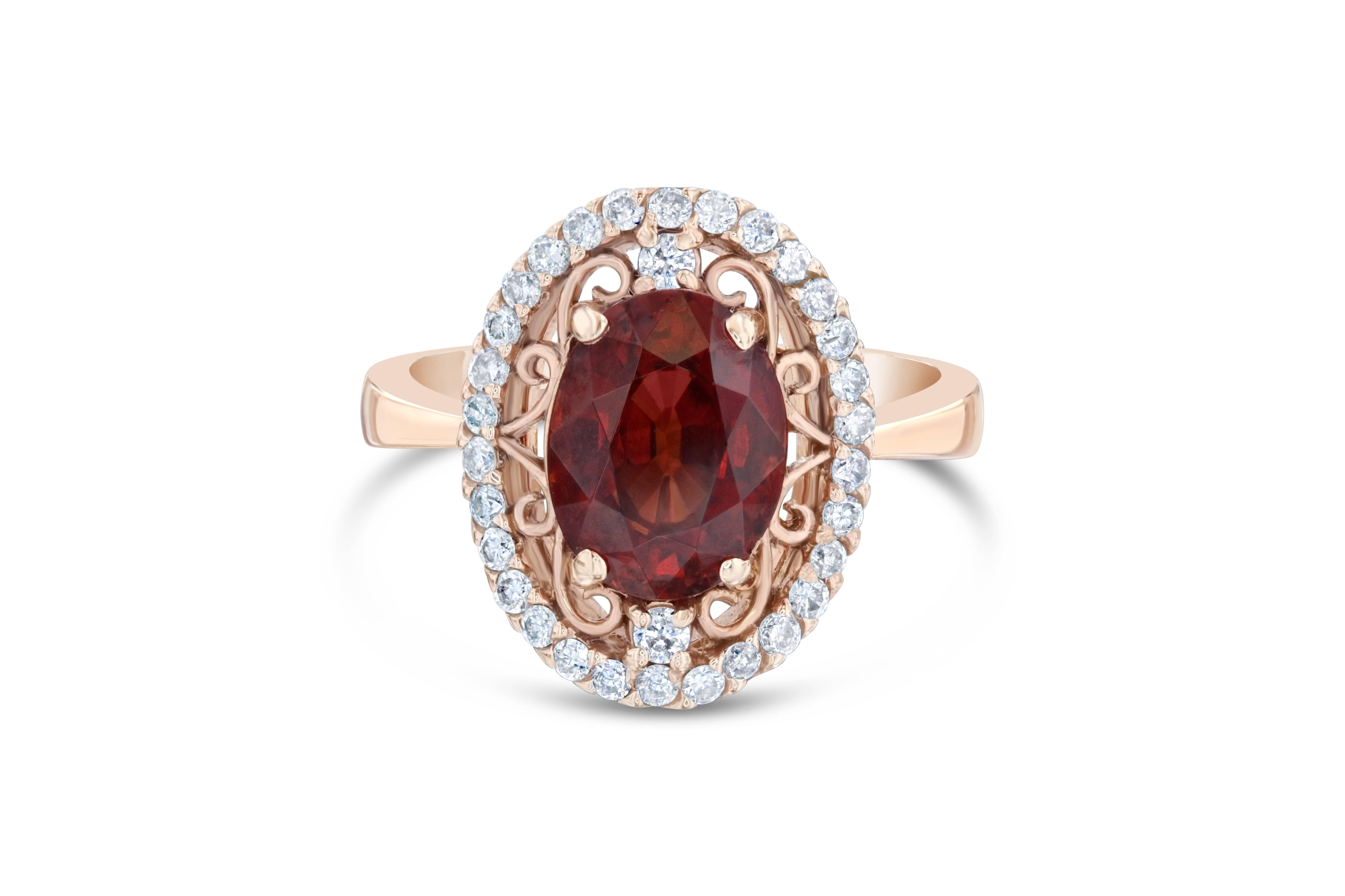 This beautiful ring has a 3.49 carat Oval Cut Spessartine set in the center of the ring. A Spessartine is a natural stone that is actually a part of the Garnet family of stones. The ring is surrounded by 32 Round Cut Diamonds that weigh 0.38 carat.
