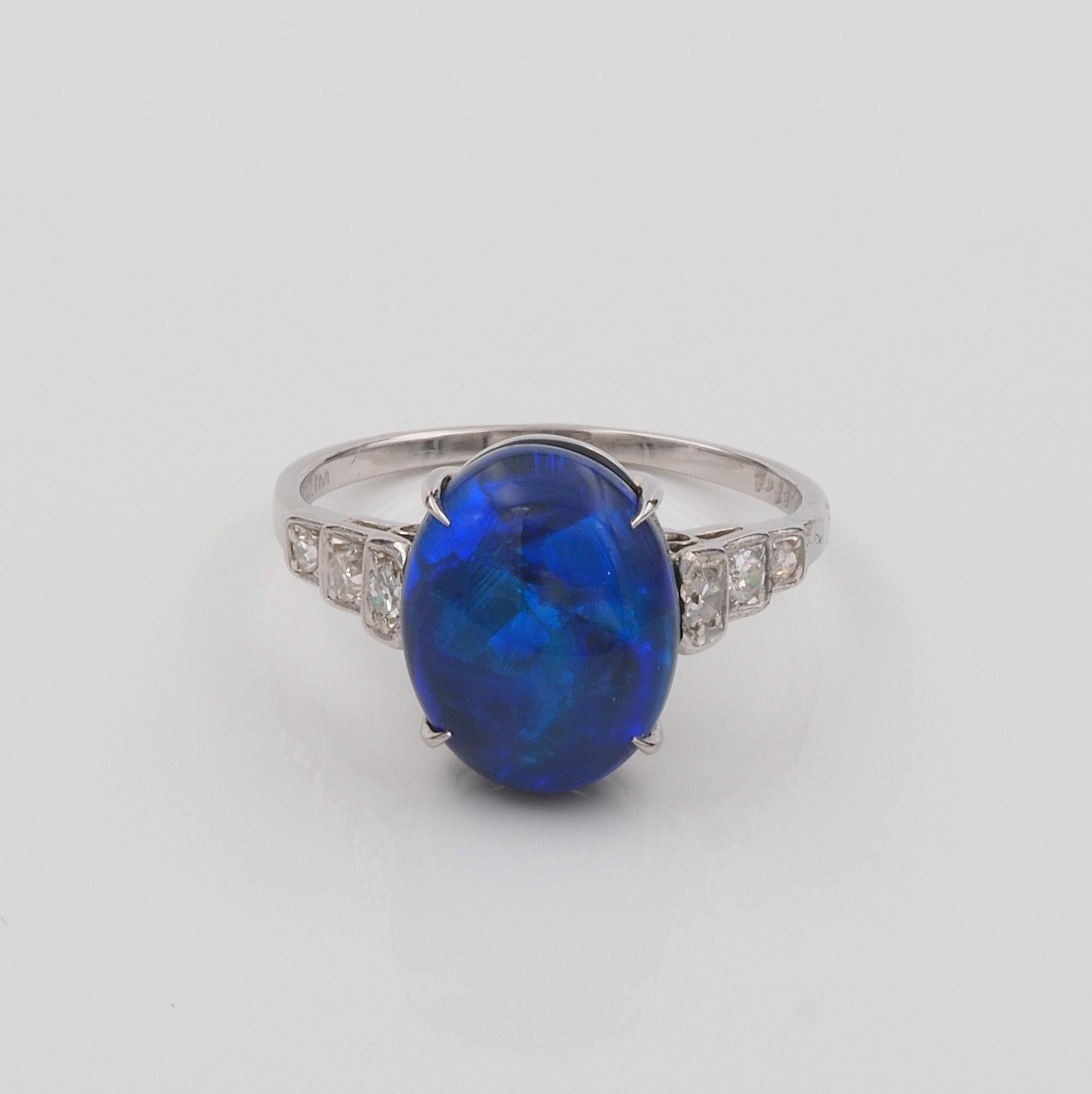 This striking vintage ring is 1930 ca.
Hand crafted of solid Platinum as unique at the highest standards
The real star is the center solid Black Opal with Green and Blue flashes on a dark body, Australian origin, 3.87 Ct in weight (11.74 x 9.20