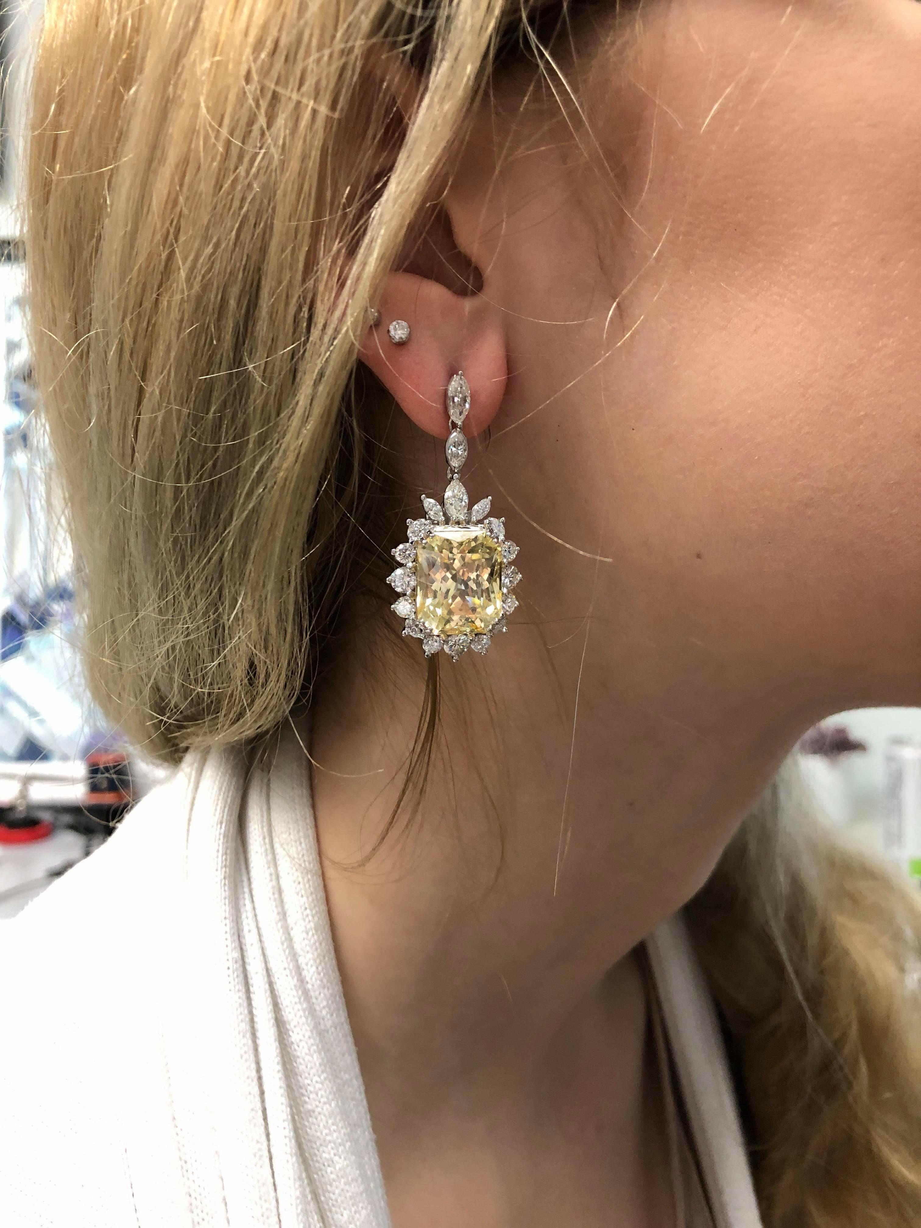 These jaw-dropping earrings are 38.71ctw in two octagonal cut, natural, yellow sapphires from Sri Lanka, not heat treatment. They are surrounded by 5.72ctw in round and marquise cut diamonds, all set in 14kt white gold earrings and platinum