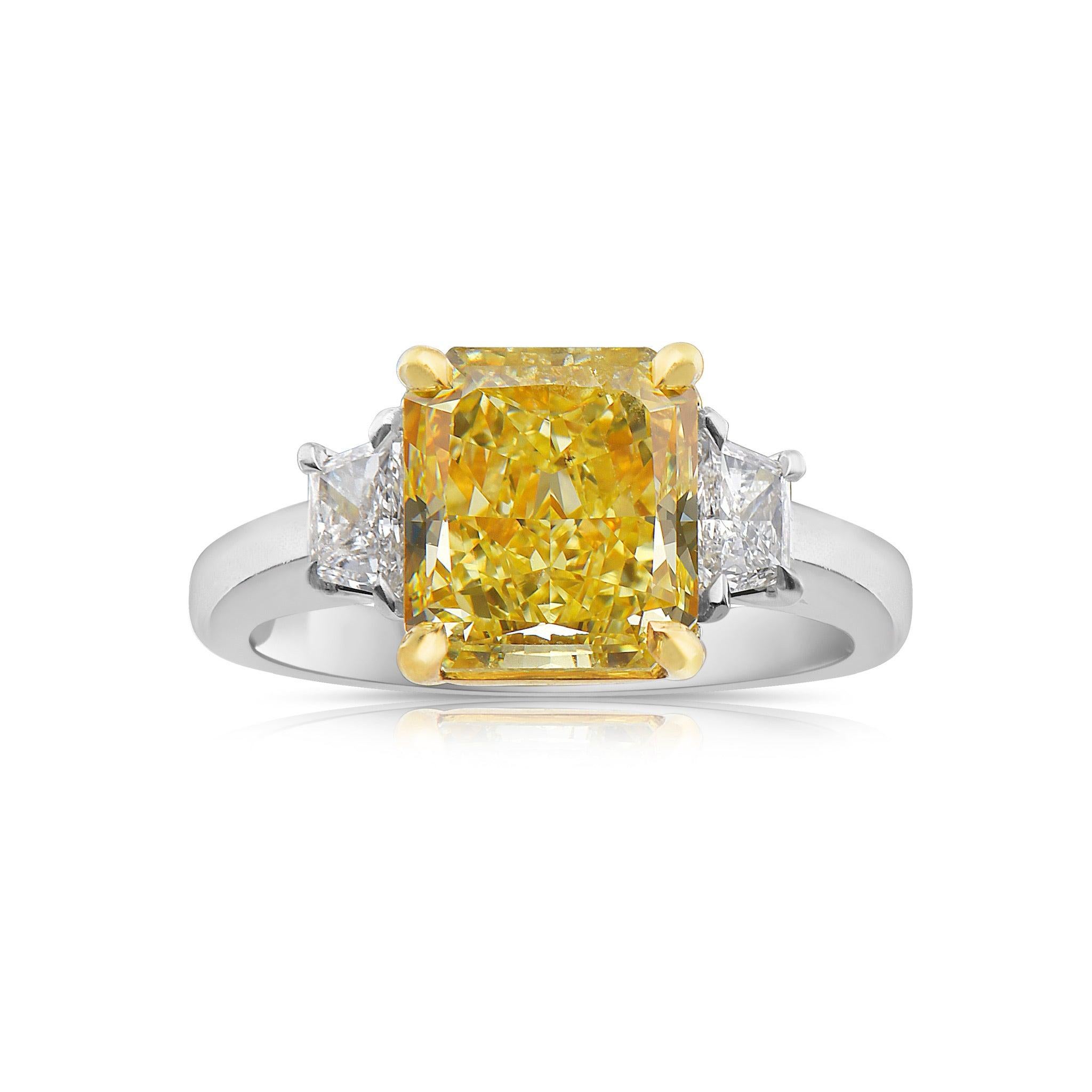 Extremely well cut and vibrant Fancy Yellow Radiant with a nice big table showcasing the yellow beauty
The diamond has Strong Blue Fluorescence but we would not buy a strong blue that would give the diamond haze or smokiness- this diamond has zero