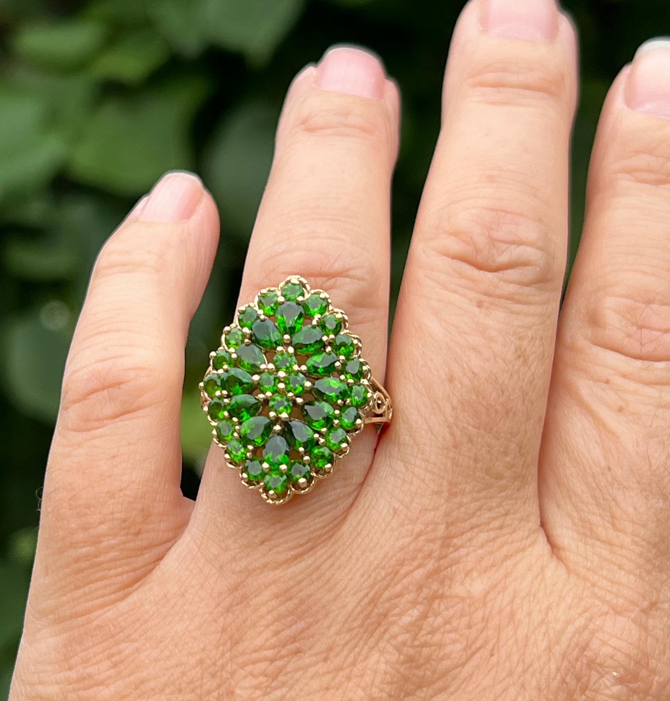 One 14 karat yellow gold cluster ring featuring thirty-six chrome diopside gemstones, including twelve pear-shaped stones (4x3mm), twenty round stones (2.7mm), and four round stones (2.4mm), with a total carat weight of 3.88 carats. Chrome diopside