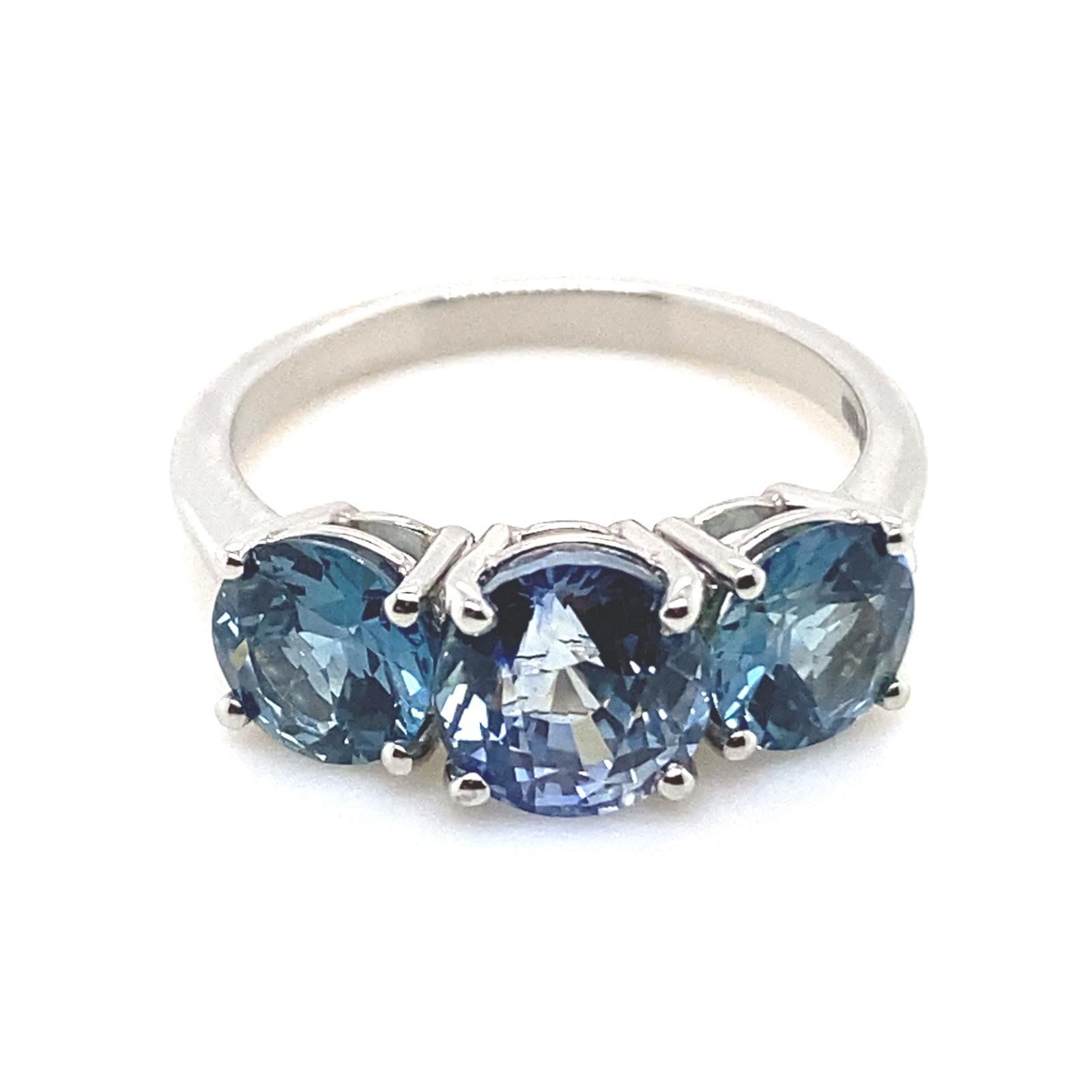 A sapphire three stone platinum engagement ring.

This beautiful sapphire engagement ring is handcrafted in platinum.

Claw set to its centre with a round cut sapphire of deep blue and framed on either side by a round cut sapphire of teal blue, for