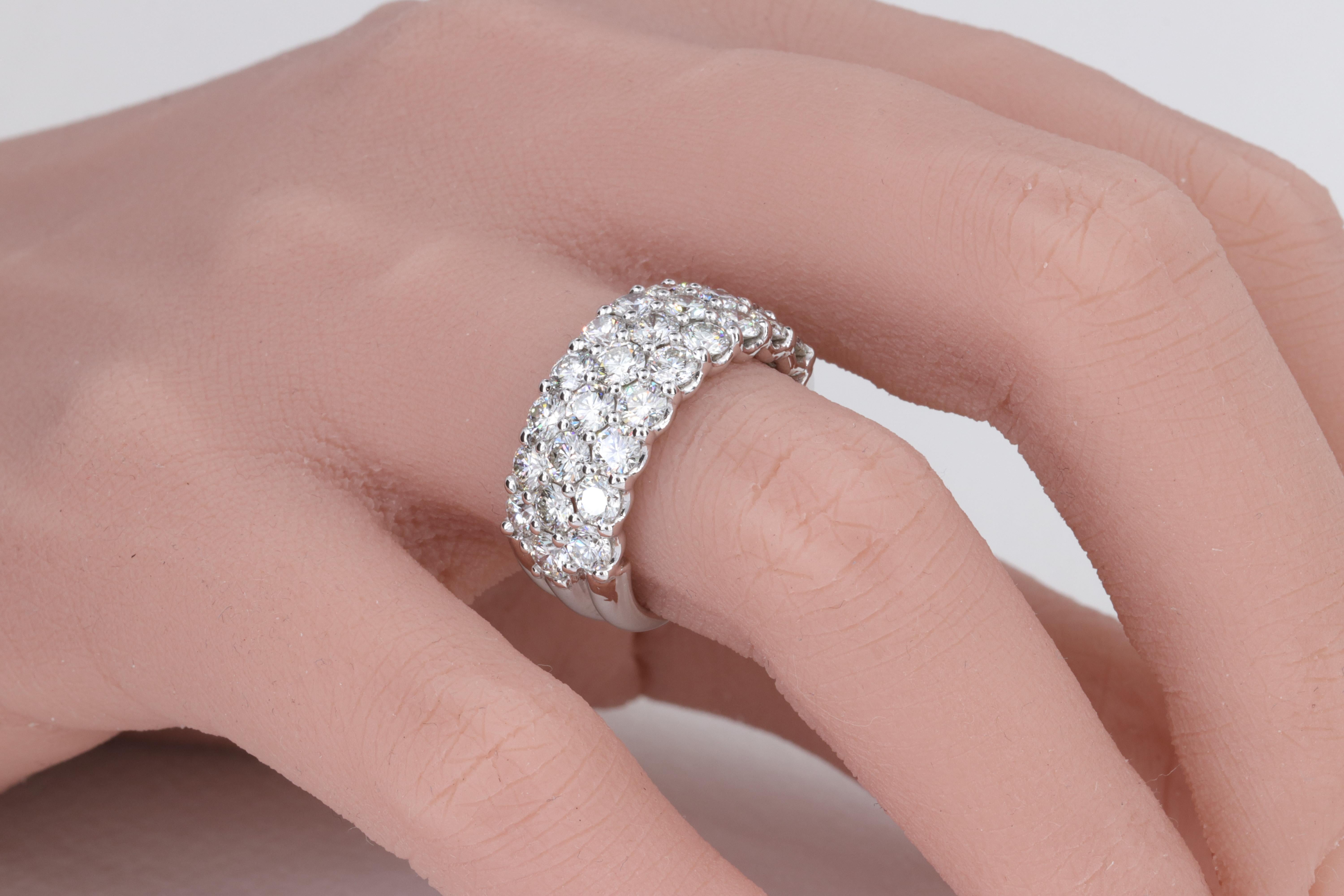 3 Row Round Brilliant Cut Diamond Anniversary Band in 18 Karat White Gold

Set with approximately 3.88 carats of F/G color Vs clarity diamonds in 18 karat white gold. 

The band measures 9mm in width at the top and 5.5mm in width at the base. 

The