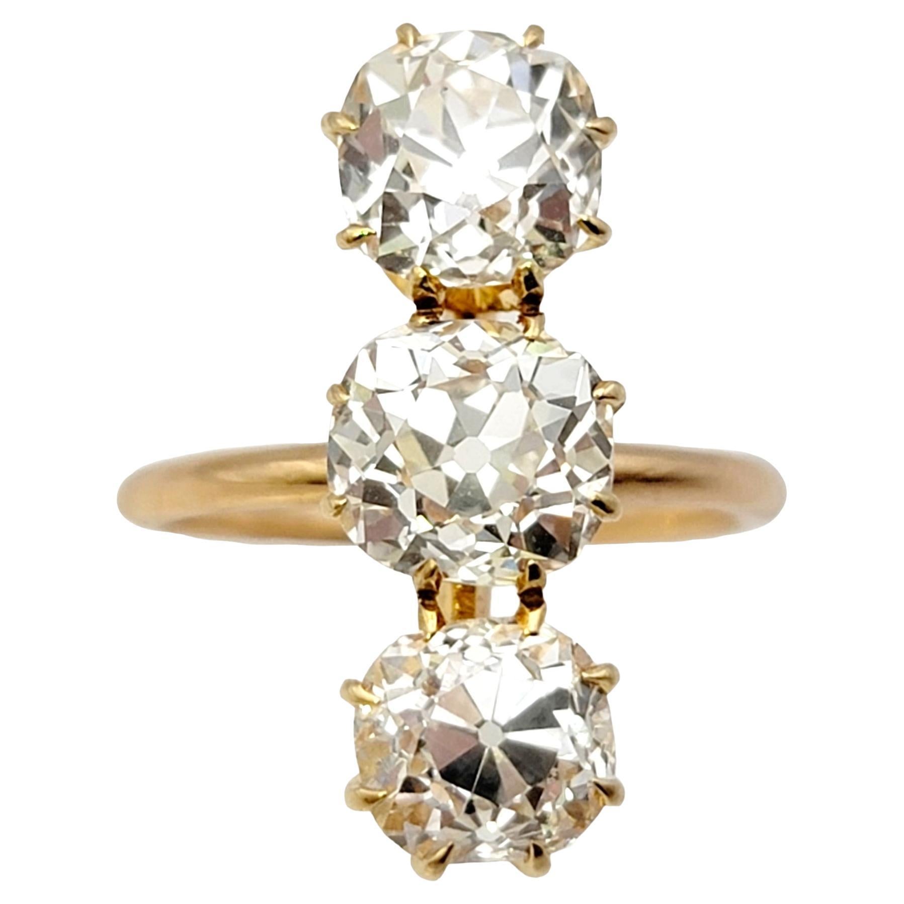 3.88 Carat Total Three-Stone Old Mine Cut Diamond Elongated 14 Karat Gold Ring For Sale
