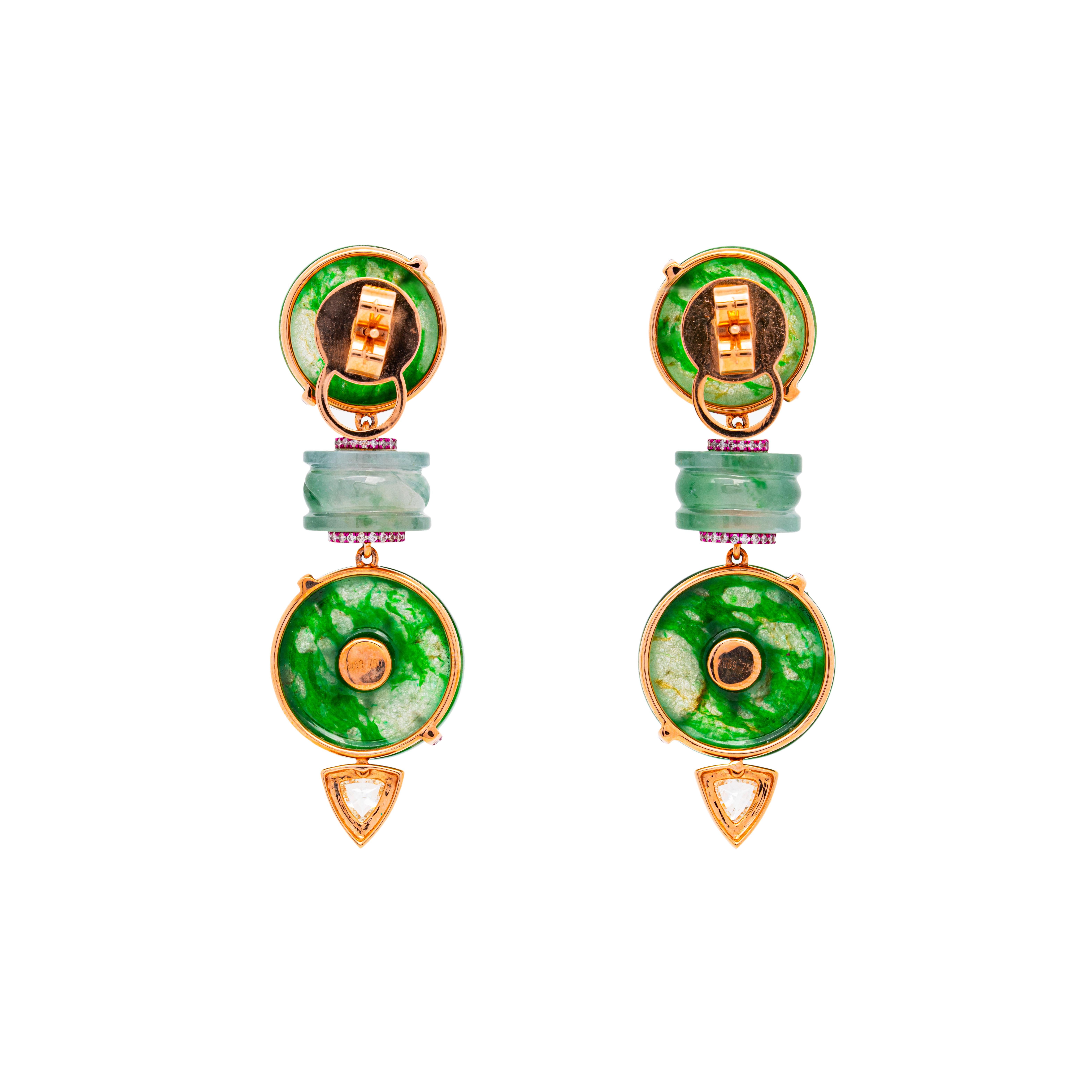 This exquisite pair of earrings from The Jade Dynasty Collection by Austy Lee features a stunning combination of Burmese Type A jadeite Ping An buckles, elegantly arranged between two strips of solid green jadeite. The design is characterized by two