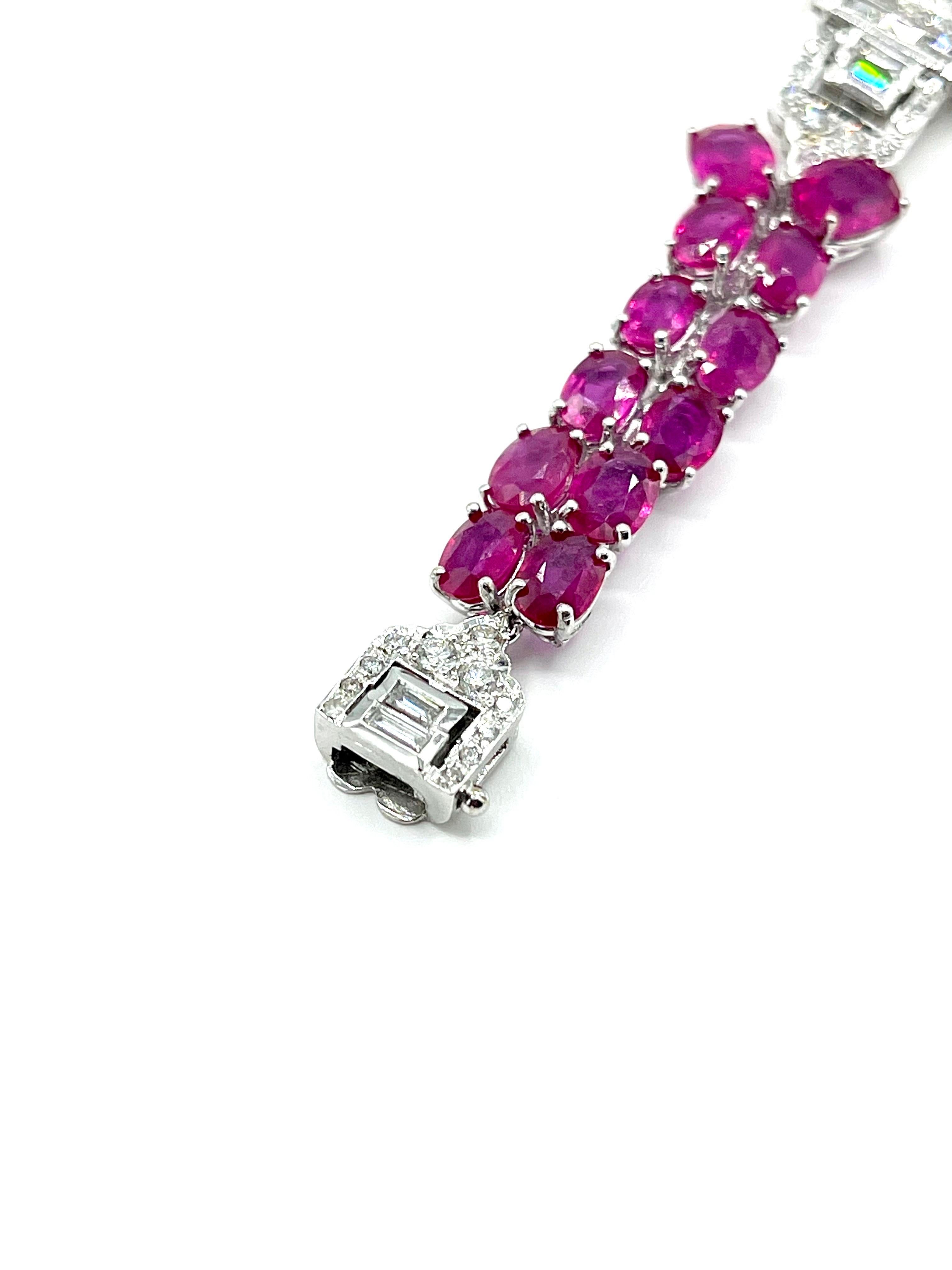 This is a show stopper!  This bracelet features 38.90 carats in beautiful Rubies, prong set in three rows in the center, and two rows on each end.  The Rubies are broken up by two Diamond stations, and a hidden Diamond box clasp, in white gold.  The