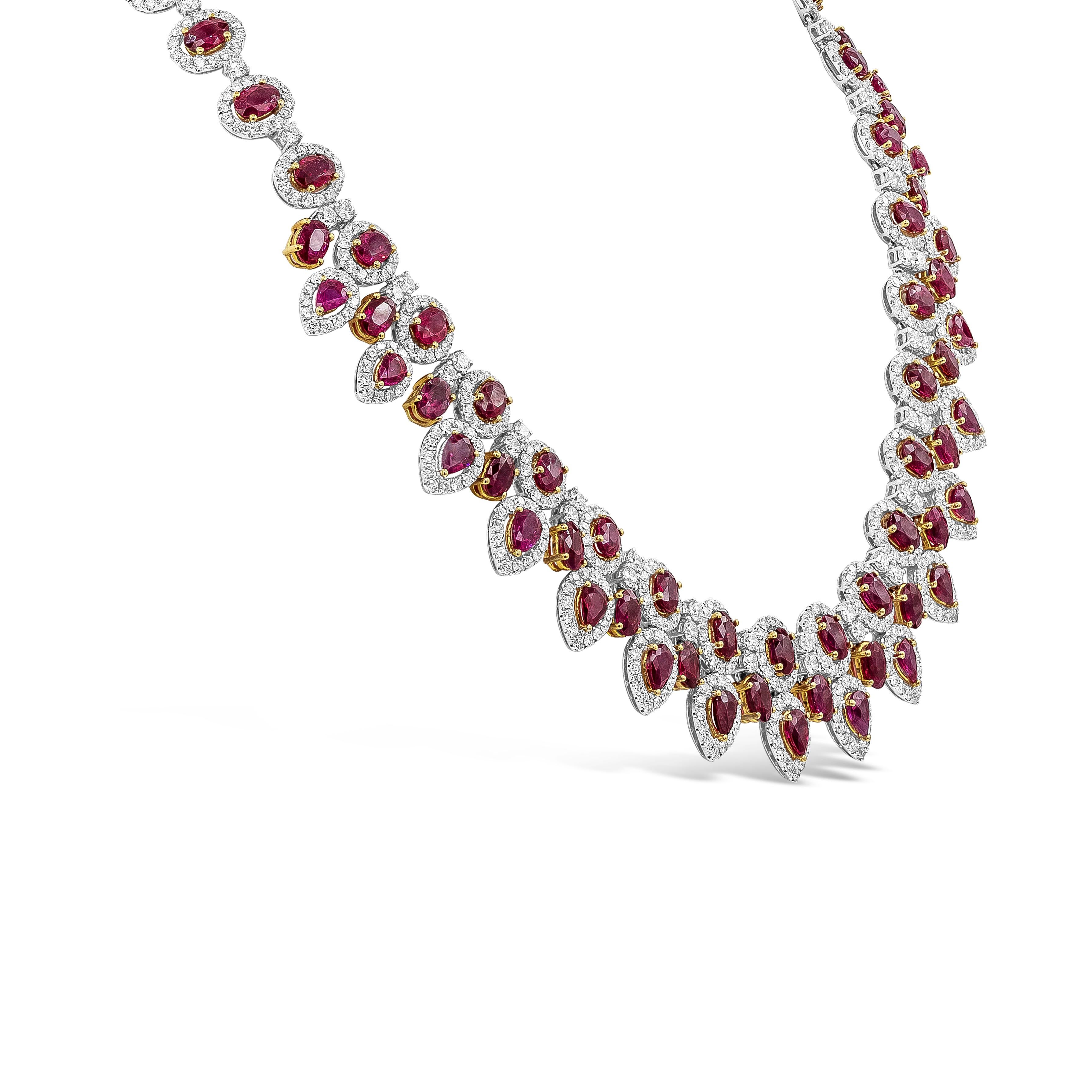 Elegant and well-crafted piece showcasing vibrant 72 pieces mixed oval cut and pear shape rubies set in a 18K yellow gold floating design weighing 38.92 carats total. Each ruby is accented with brilliant round halo diamonds weighing 14.30 carats