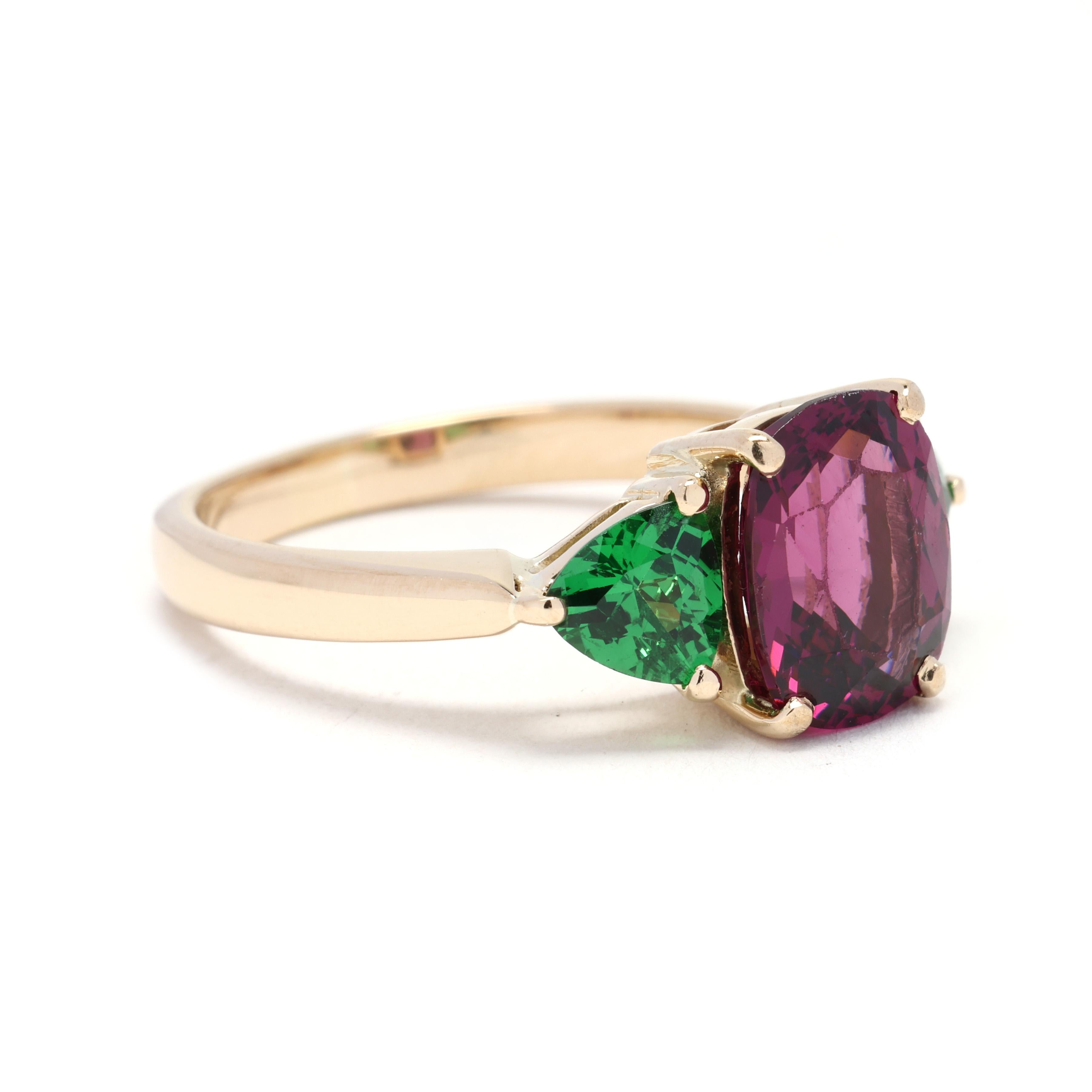 This 3.8ctw Rhodolite Garnet & Tsavorite Garnet Ring is a stunning and bold statement piece. Made from 18k yellow gold, this ring features a large oval-shaped Rhodolite Garnet center stone, surrounded by smaller round Tsavorite Garnet stones. The