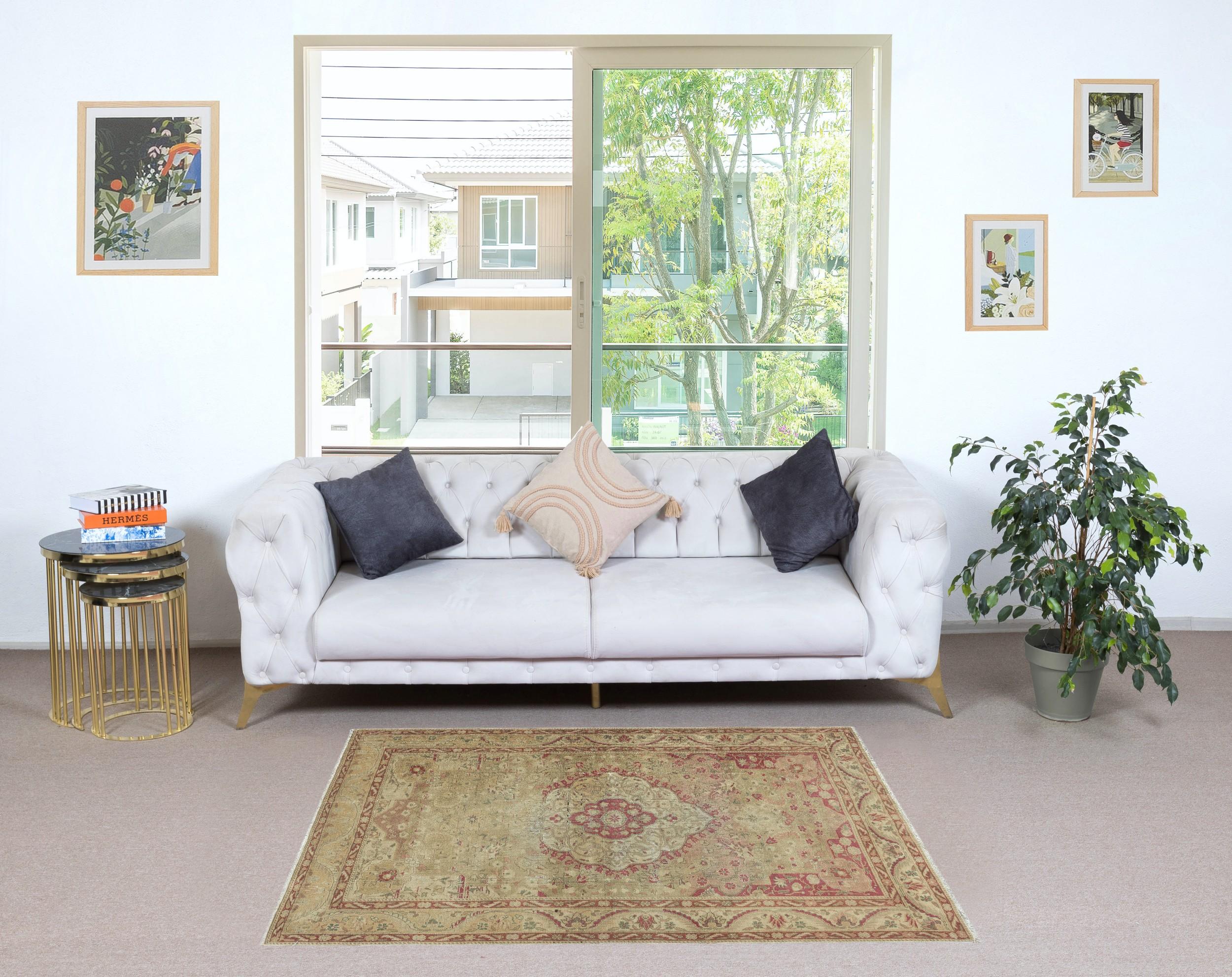 Add a touch of timeless elegance to your home with this traditional vintage hand knotted Turkish area rug, crafted from 100% premium wool. This exquisite piece captures the essence of traditional Anatolian craftsmanship, featuring intricate patterns
