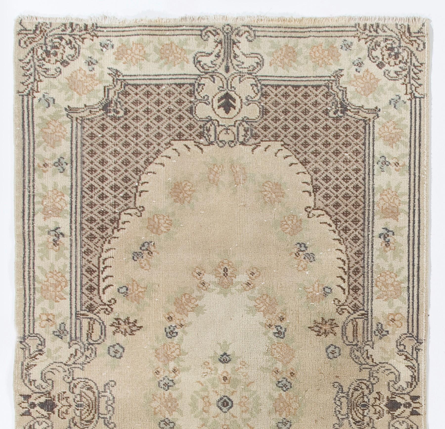 A finely hand knotted mid-20th century area rug from Central West Anatolia with soft colors and low wool pile on cotton foundation. It features a French-Aubusson inspired floral design in soft, neutral tones of beige, sand, taupe and brown. 

The