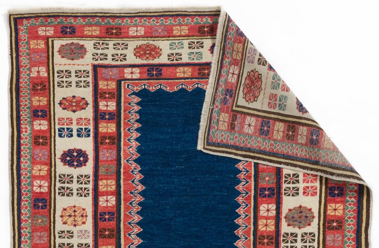 A vintage handmade Caucasian rug from South East Azerbaijan with all natural dyes and a dramatic design with a beautiful solid indigo blue field.
Medium, soft wool pile on wool foundation, very good condition.