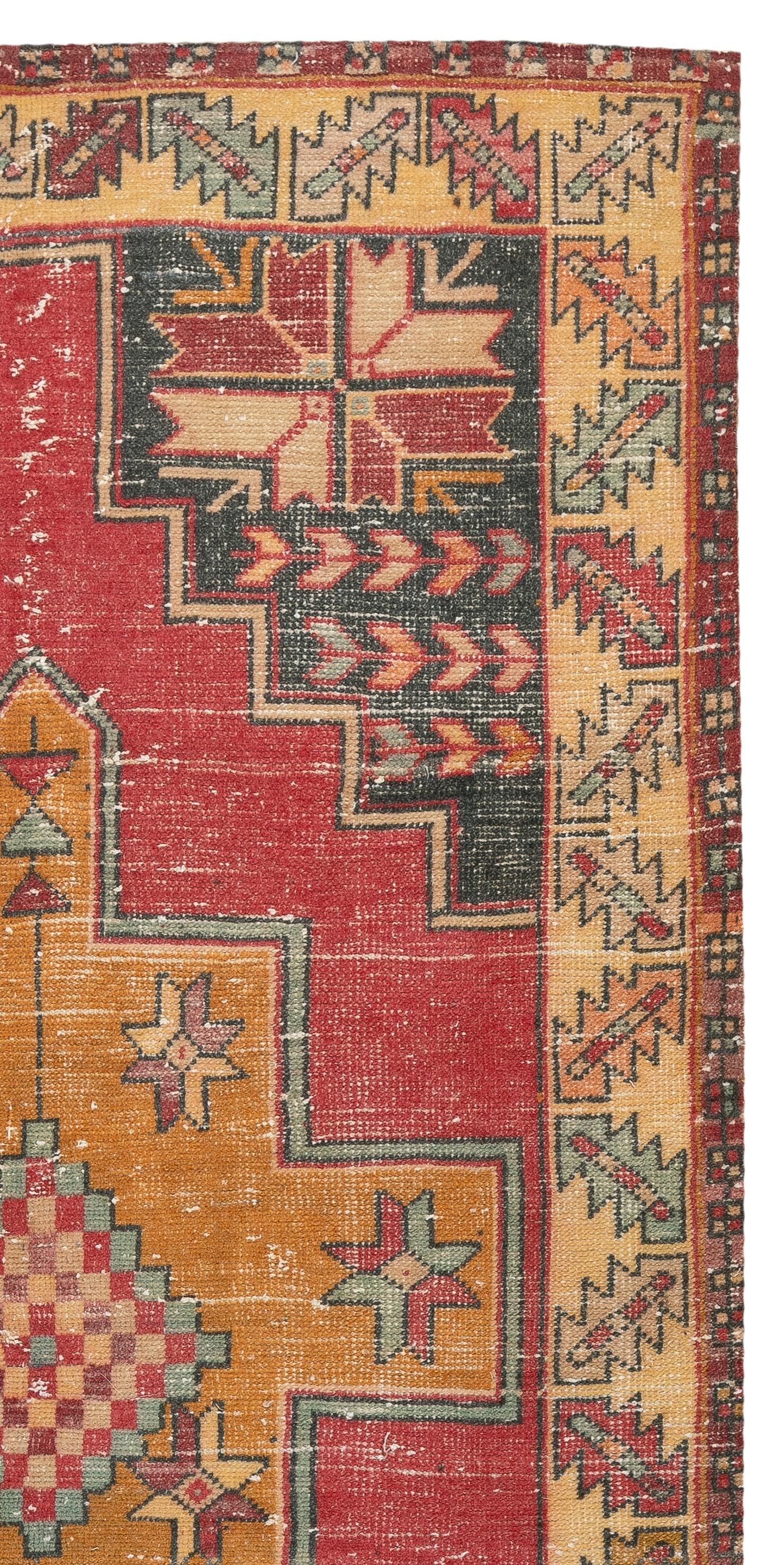 A vintage village rug from Turkey. It features multiple medallions against in saturated gold with light blue borders against a red field and large corner pieces and a main border featuring geometric star and leaf motifs. Finely hand-knotted with