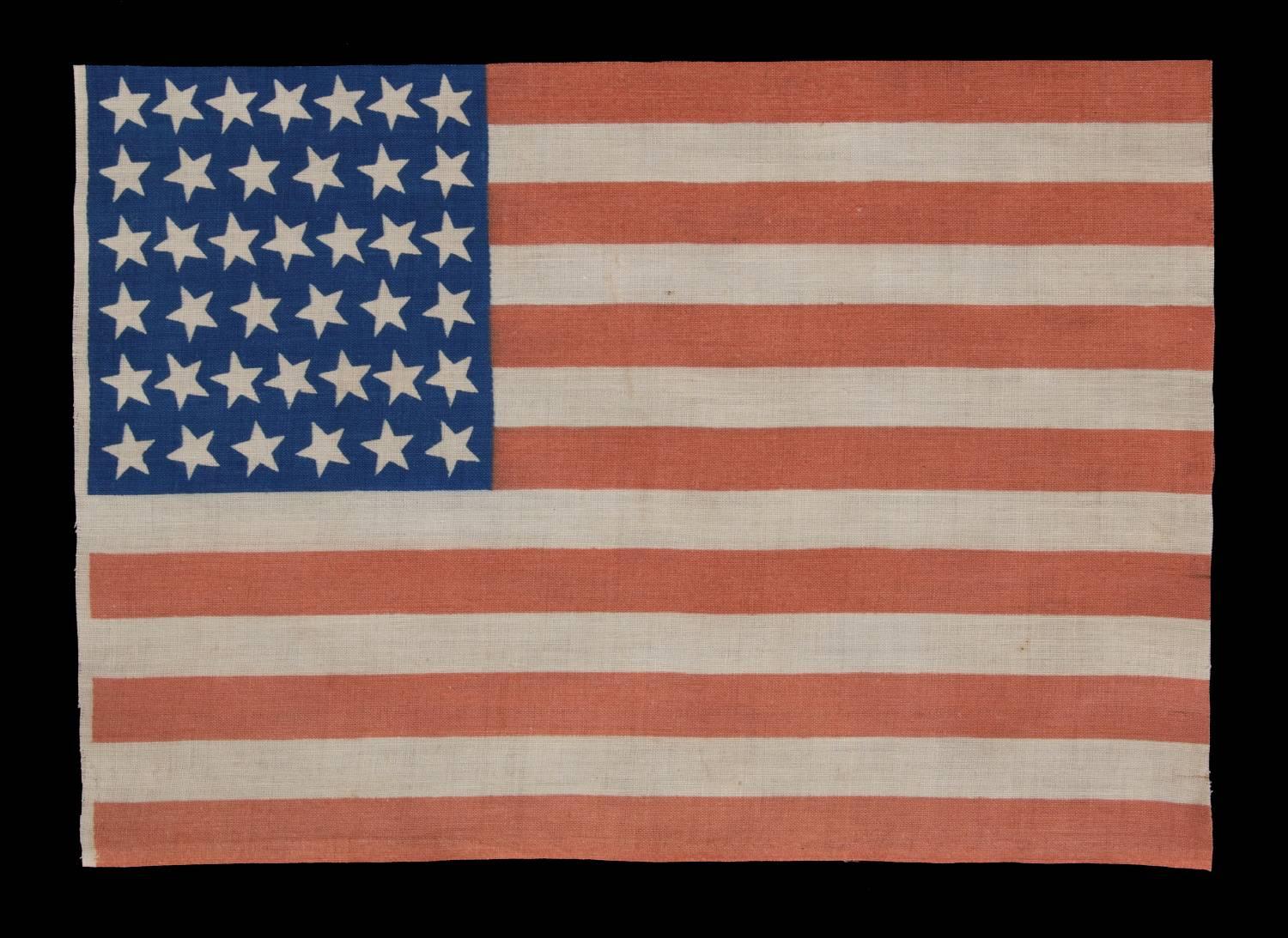 39 canted stars on an antique american flag dating to the 1876 centennial, never an official star count, reflects the anticipated arrival of the dakota territory:

39 star American parade flag, printed on plain weave cotton. Note how the stars,