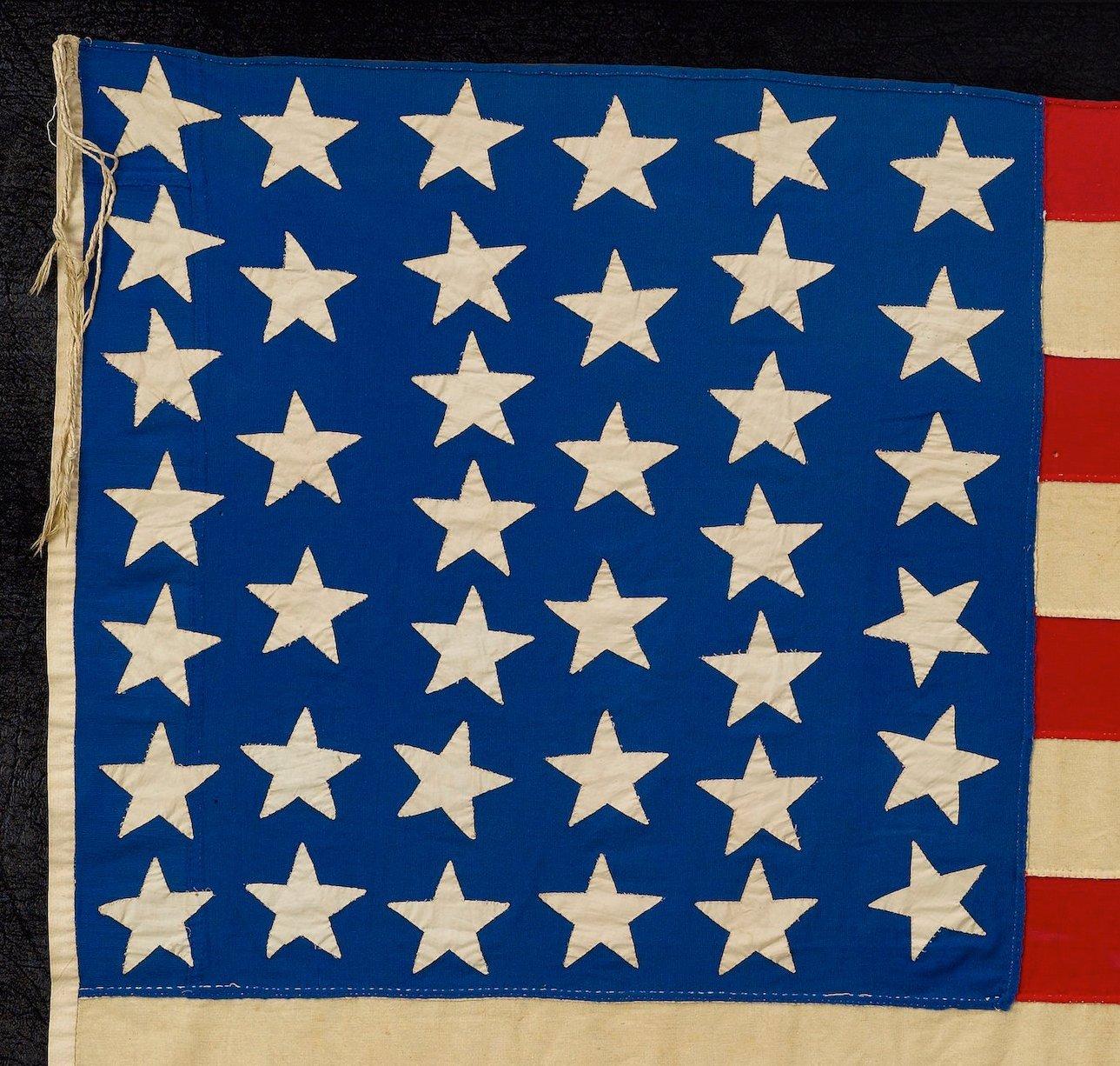 Presented is a 39-star American flag, dating to 1889 and celebrating North Dakota's statehood.  This very large family flag was fully hand-cut and sewn, impressive in both its construction and sheer size. The flag's canton features a 7-6-7-6-7-6