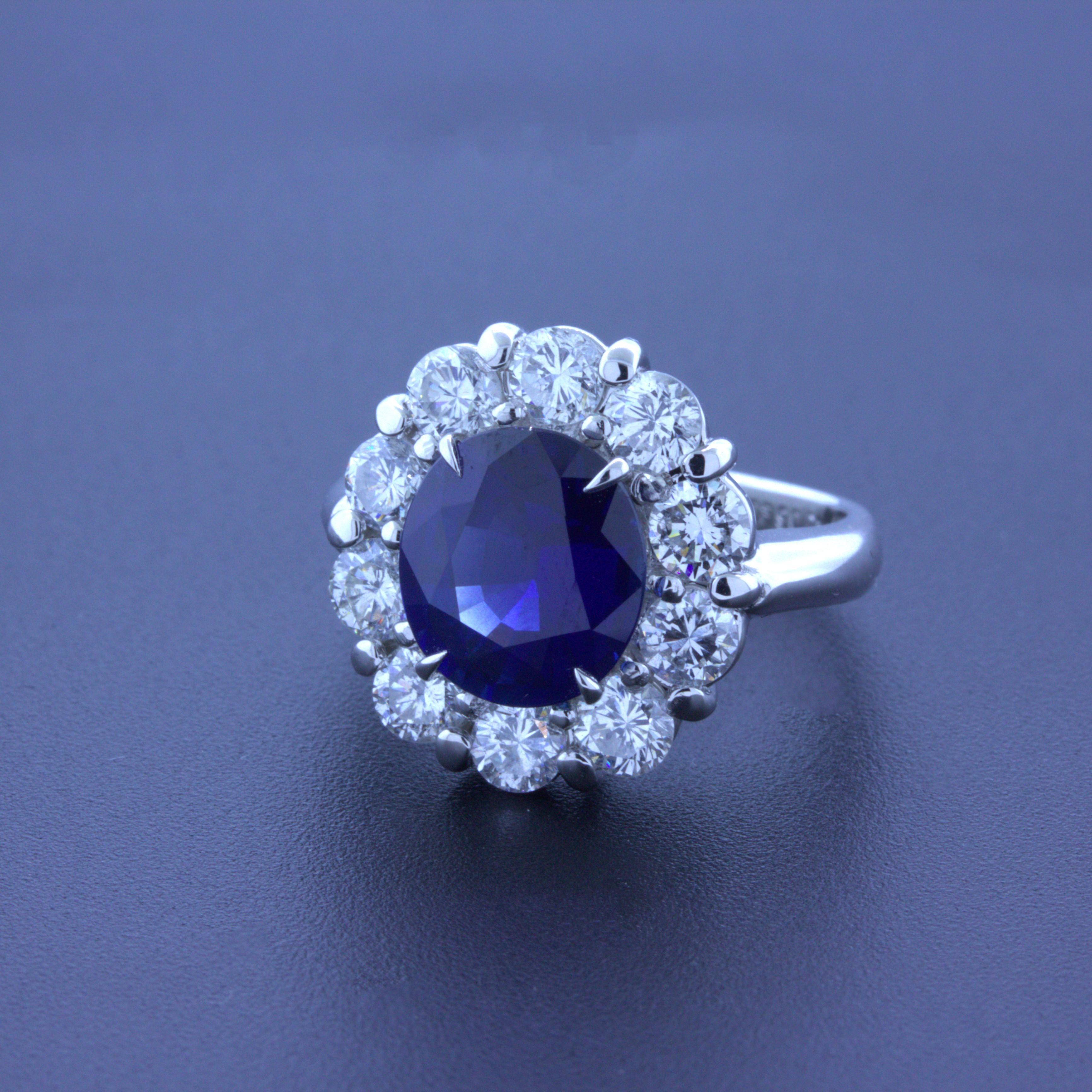 A classic blue sapphire diamond halo platinum ring! The sapphire weighs 3.90 carats and has a rich vivid blue color that is perfectly even across the entire stone. It has a lovely oval-shape and is certified by the GIA as natural. It is complemented