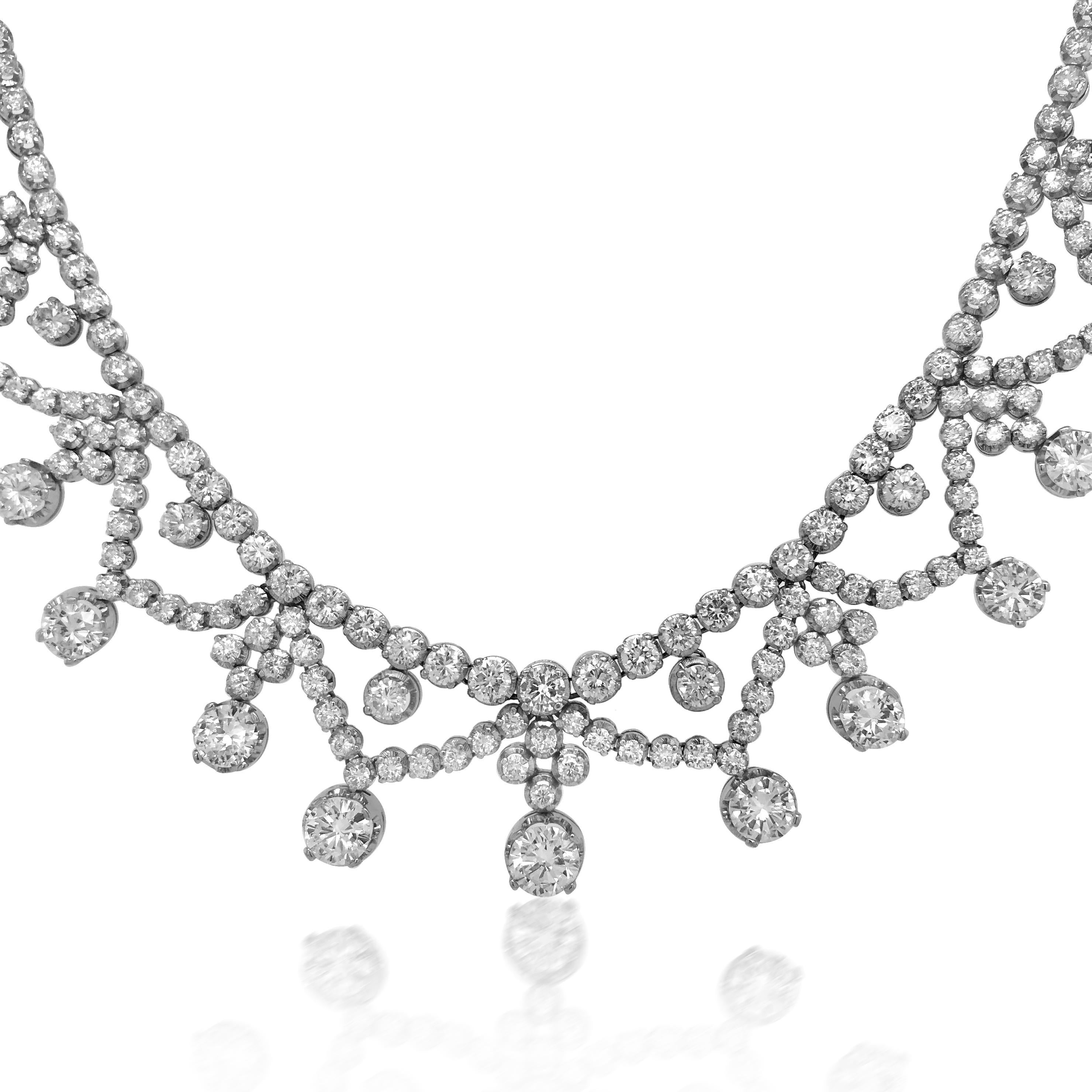 This conspicuous diamond necklace is crafted in solid 18K white gold, weighing 69 grams and measuring 45cm (17 3/4'') long. Depicting 13 genuine large round brilliant cut diamonds weighing approx. 15cttw and other 212 RBC diamond around the