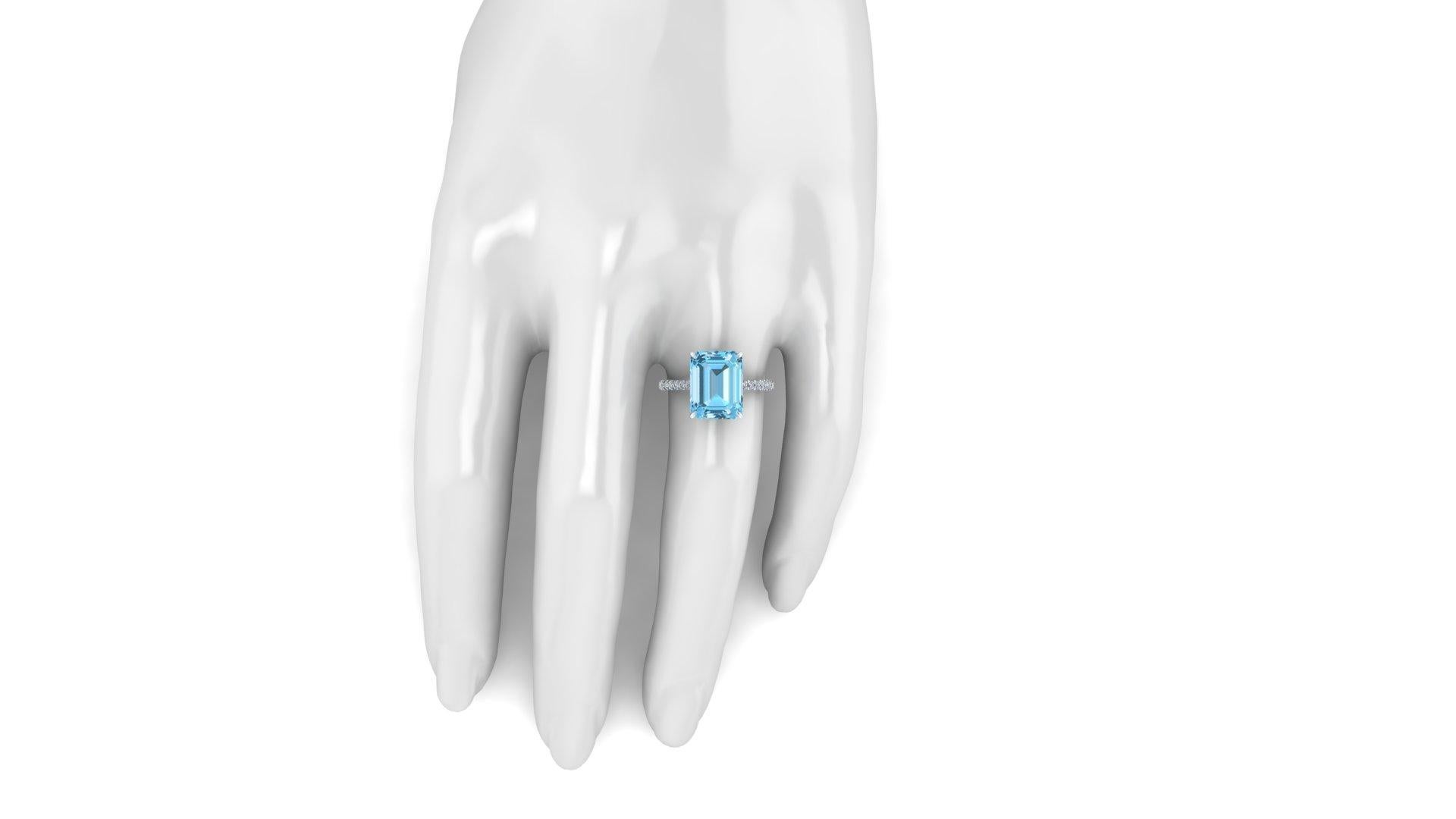 3.62 carat Aquamarine, emerald cut, very high quality color, superior blue, eye clean gem, accompanied a pave' of bright diamonds of approximately  total carat weight of 0.38 carat, set in an hand crafted, delicate and sophisticated looking 14k whie