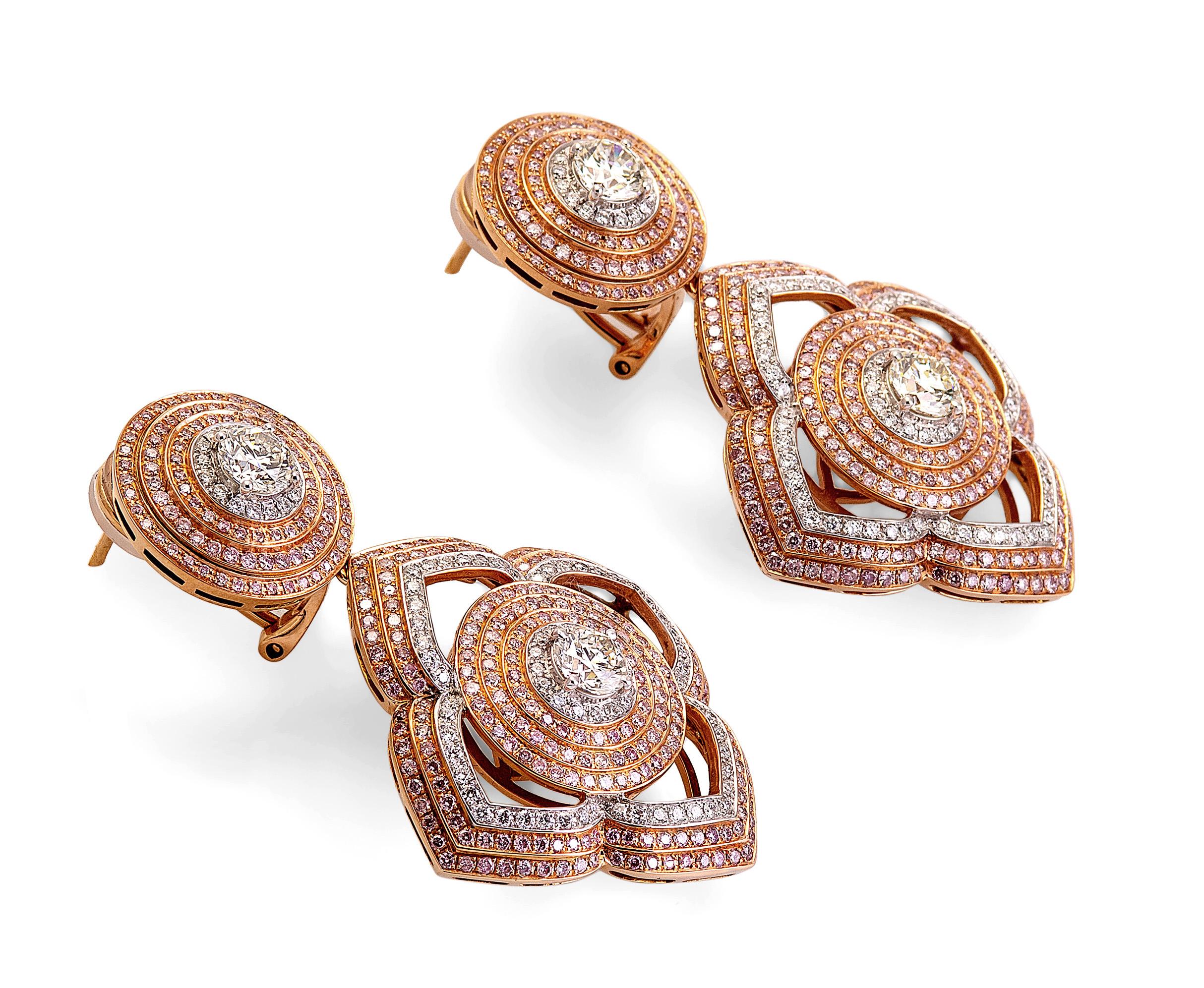 A stunning pair of large earrings with 3.90 carats in pave Natural Vivid Pink Diamonds, 2.80 carats in pave F-G/VS white diamonds, and 1.30 carats total in individual center diamonds, designed by world-renowned jewelry designers, Danuta and Jonathan