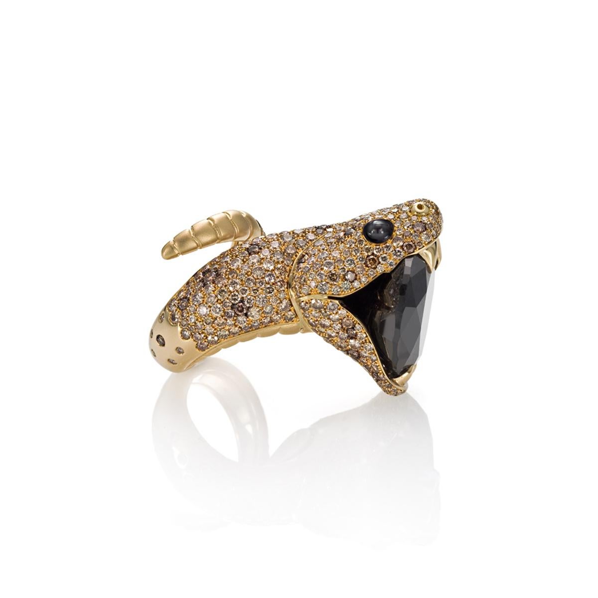 This bold fashion ring is made for people with a strong personality. Beautifully crafted in 18 Kt yellow gold, this wrap ring is shaped in a diamond-pavé snake clenching a sizable black diamond between its teeth. The whole surface of the head of the