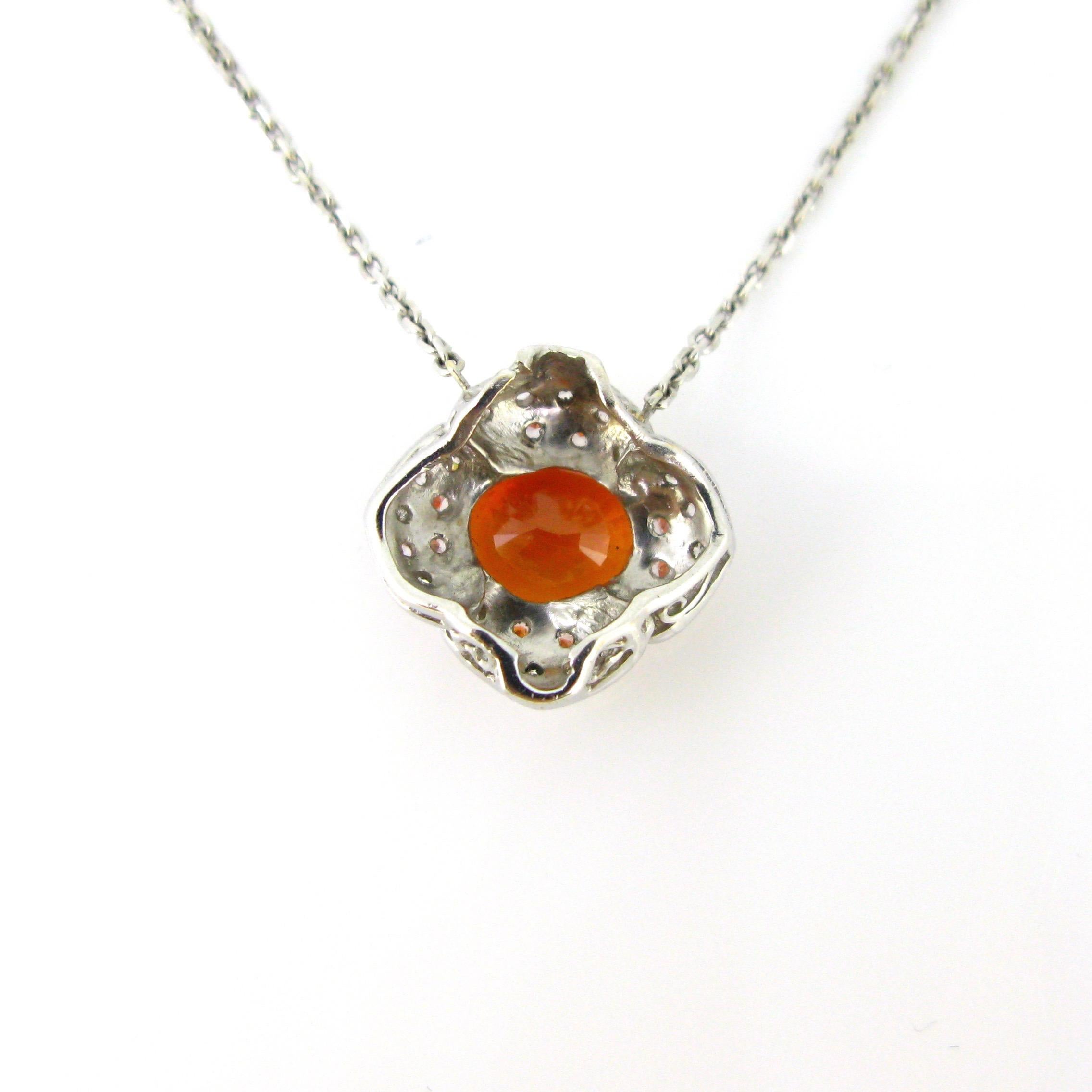 This necklace is made in 18k white gold. The pendant is set with a vivid orange sapphire weighing around 3.90ct. It is surrounded with 4 petals adorned with single cut diamonds. It has a nice flowery design. This necklace is very easy to wear