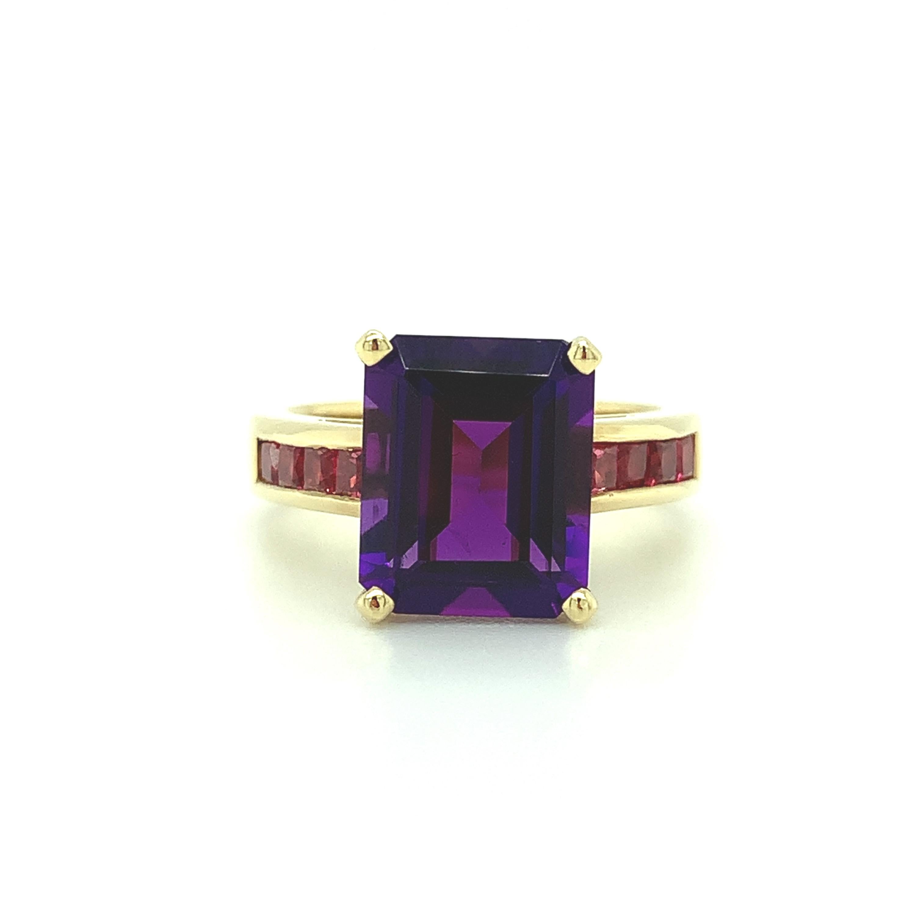 A beautiful emerald-cut, royal purple amethyst is combined with channel-set, bright princess-cut pink spinels in this stunning 18k yellow gold cocktail ring. The fuchsia pink flashes within the amethyst are highlighted by the sparkling fuchsia color