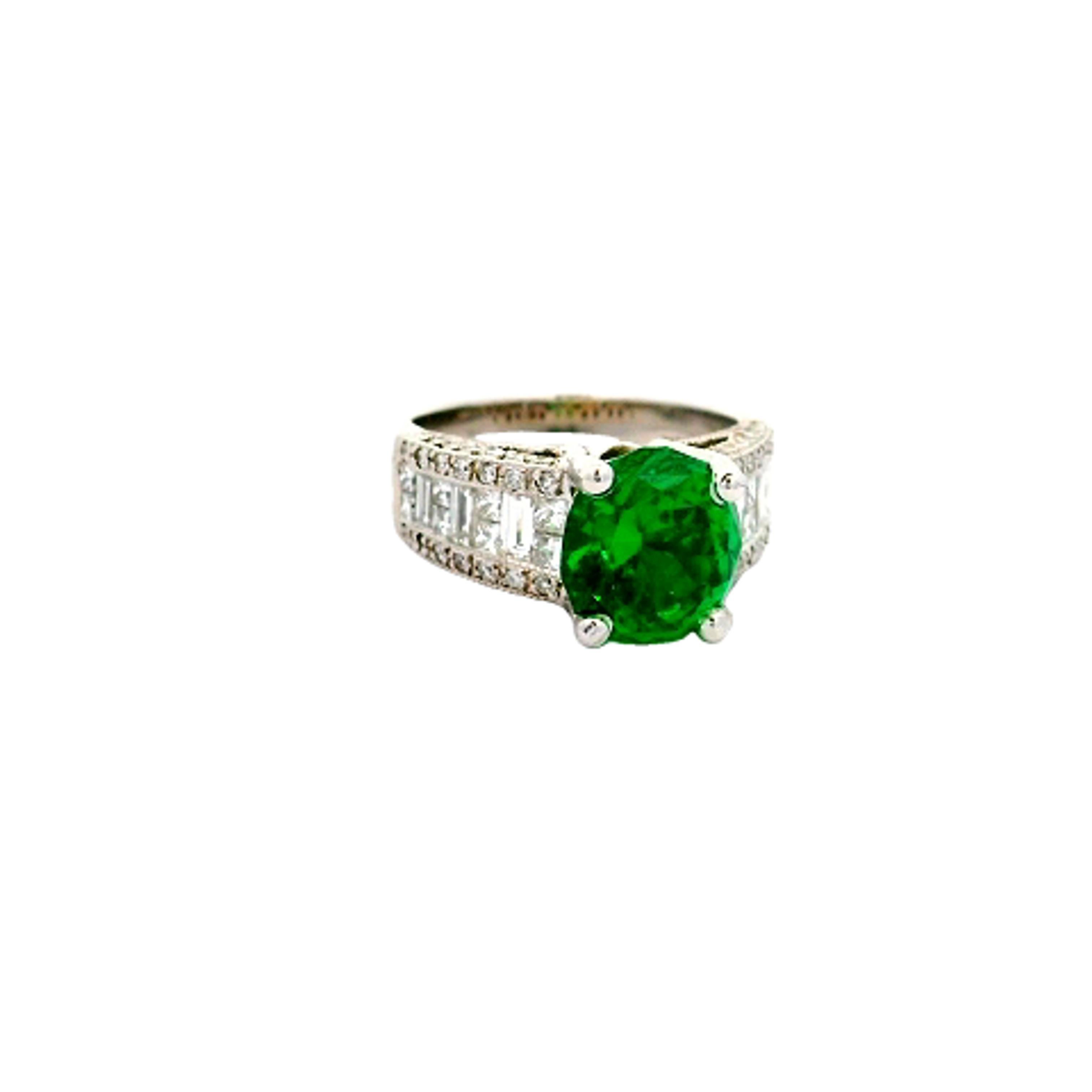 A modern and elegant ring featuring a 3.92 carat oval-cut tsavorite garnet as its centerpiece. The vivid green hue of the tsavorite is exceptionally fine making this stone extremely rare for its combination of size, color, and quality. It is