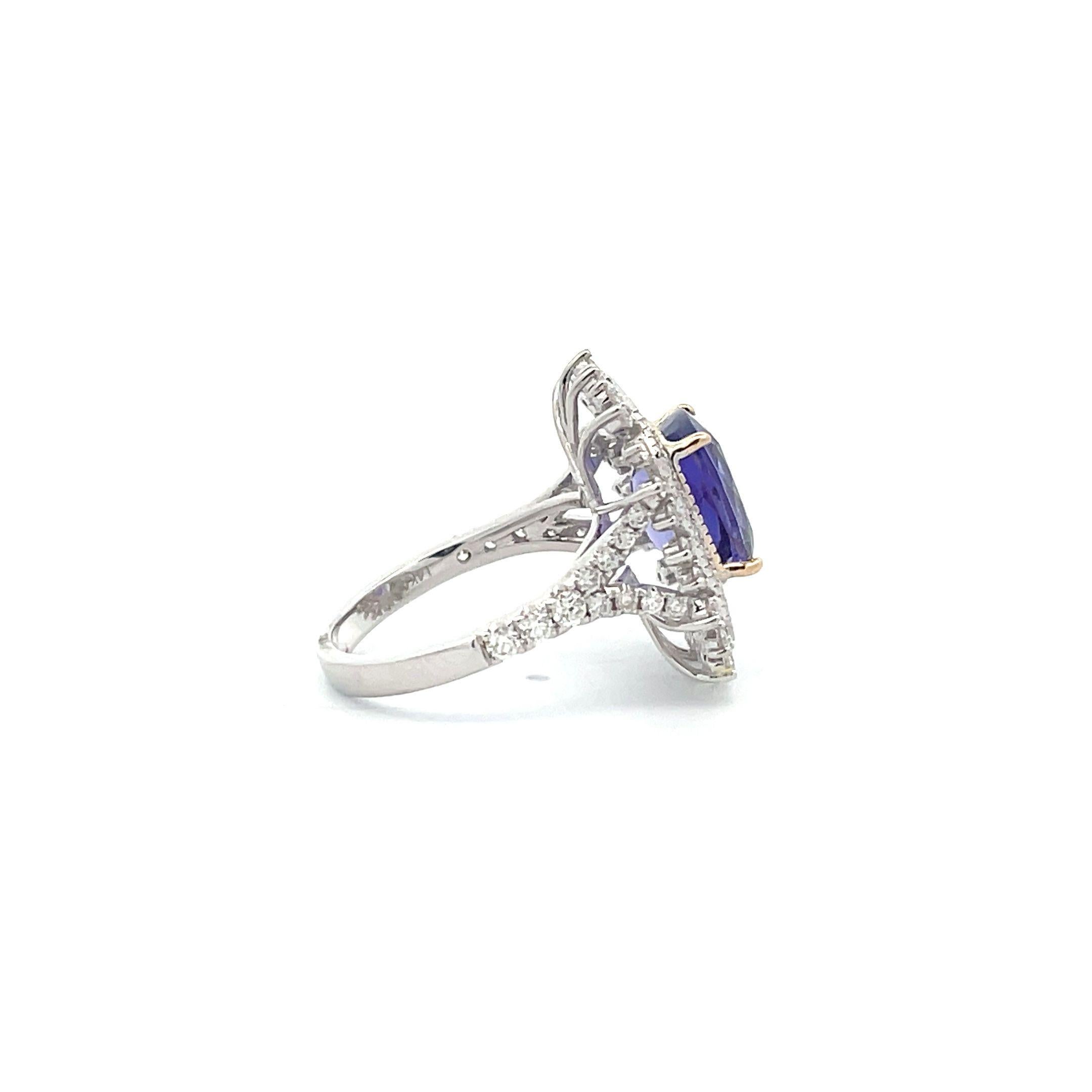 A delicate combination of 3.92 ct. cushion-cut Tanzanite, and a 0.99 ct. Diamond halo makes this Edwardian engagement ring with diamond accents a stunning choice for your special day! Beautifully crafted by professional artisans using 14K White Gold