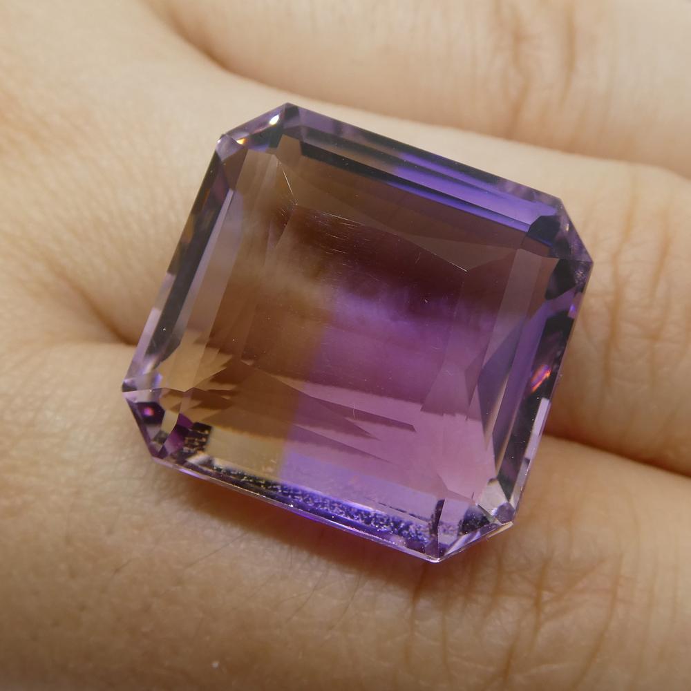 Description:

Gem Type: Ametrine
Number of Stones: 1
Weight: 39.25 cts
Measurements: 20.60x19.40x11.50 mm
Shape: Square
Cutting Style Crown: Step Cut
Cutting Style Pavilion: Step Cut
Transparency: Transparent
Clarity: Very Slightly Included: Eye