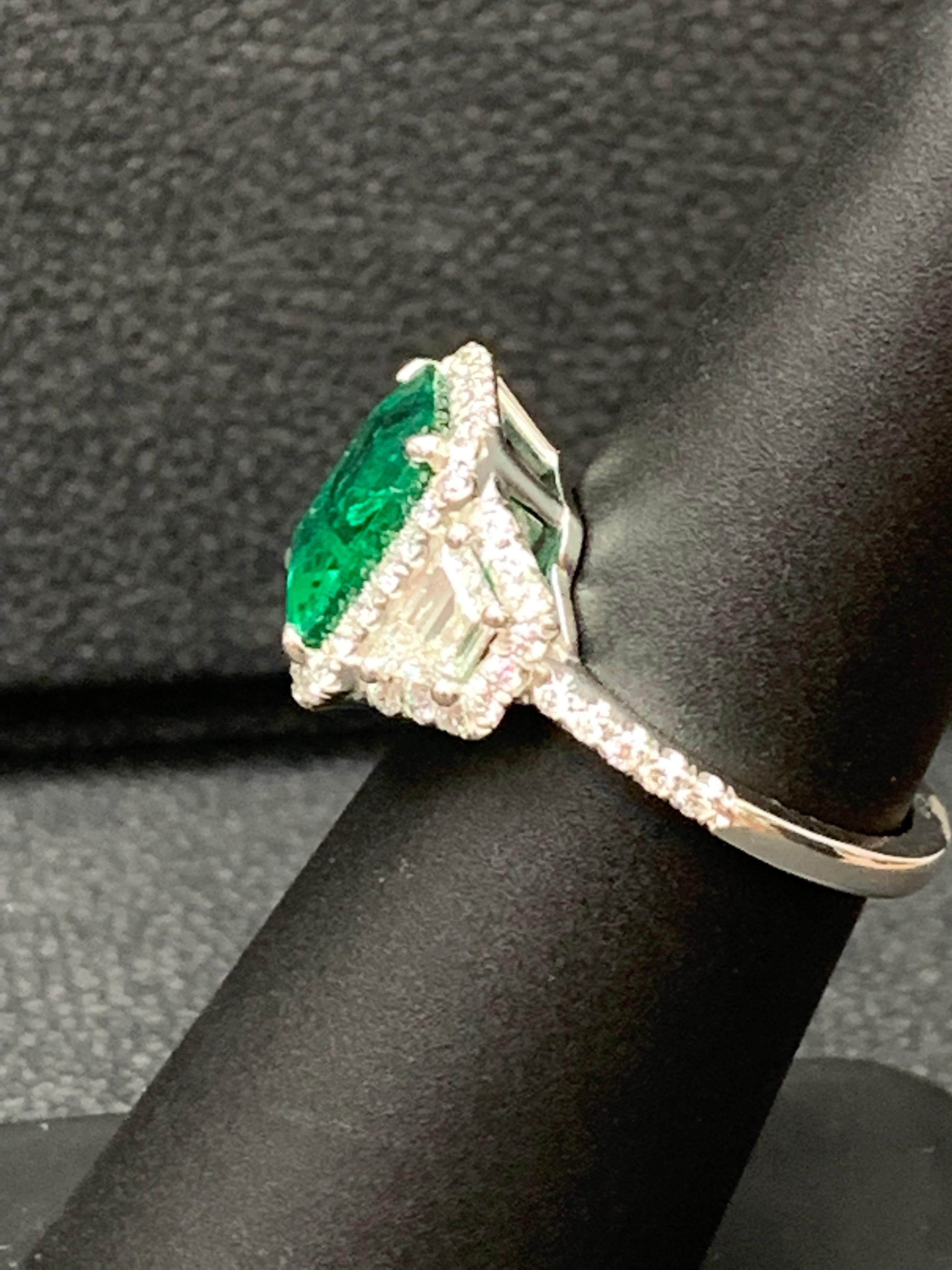 Modern 3.93 Carat Emerald Cut Emerald and Diamond Three-Stone Halo Ring in Platinum For Sale