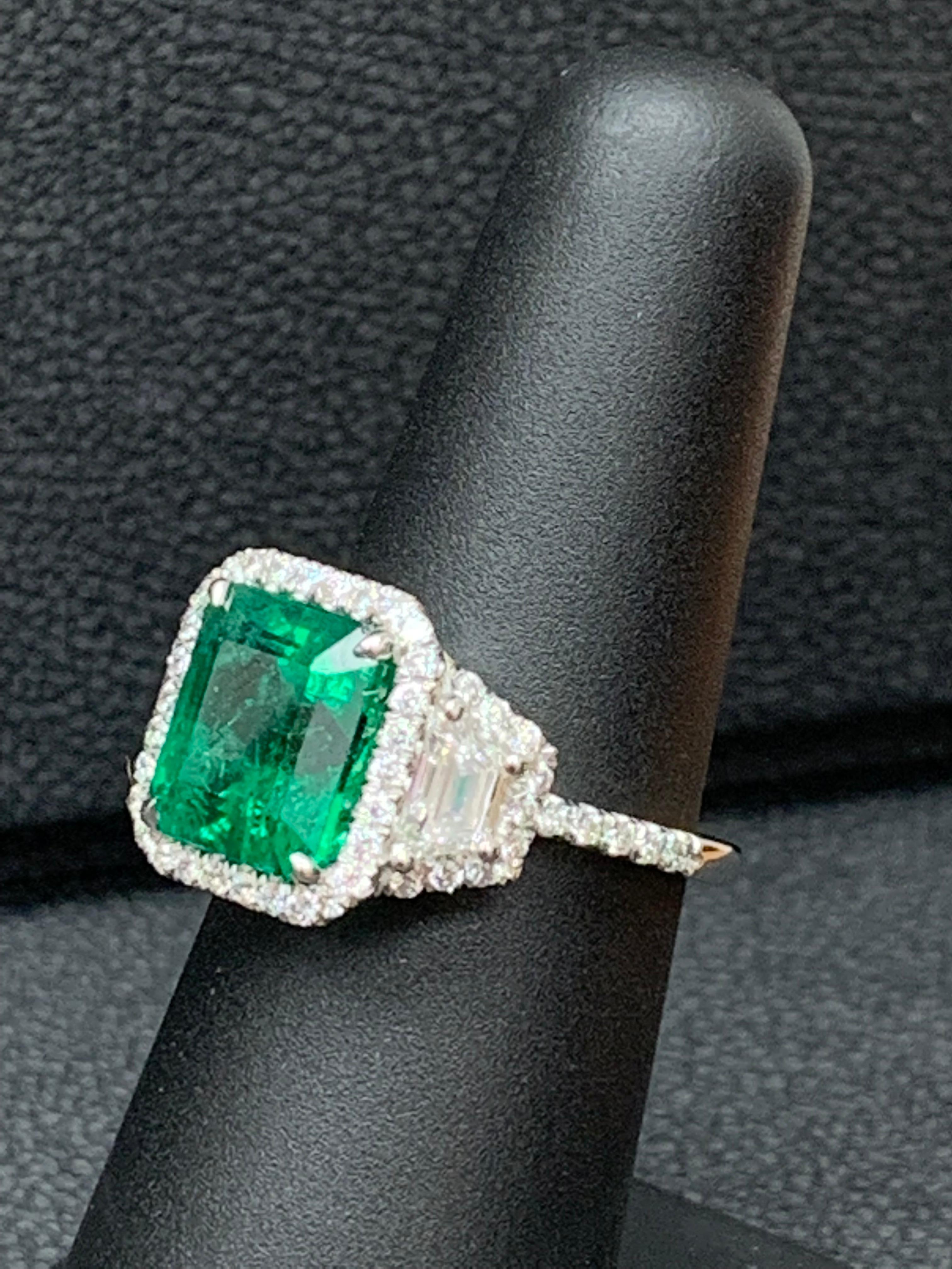 3.93 Carat Emerald Cut Emerald and Diamond Three-Stone Halo Ring in Platinum In New Condition For Sale In NEW YORK, NY