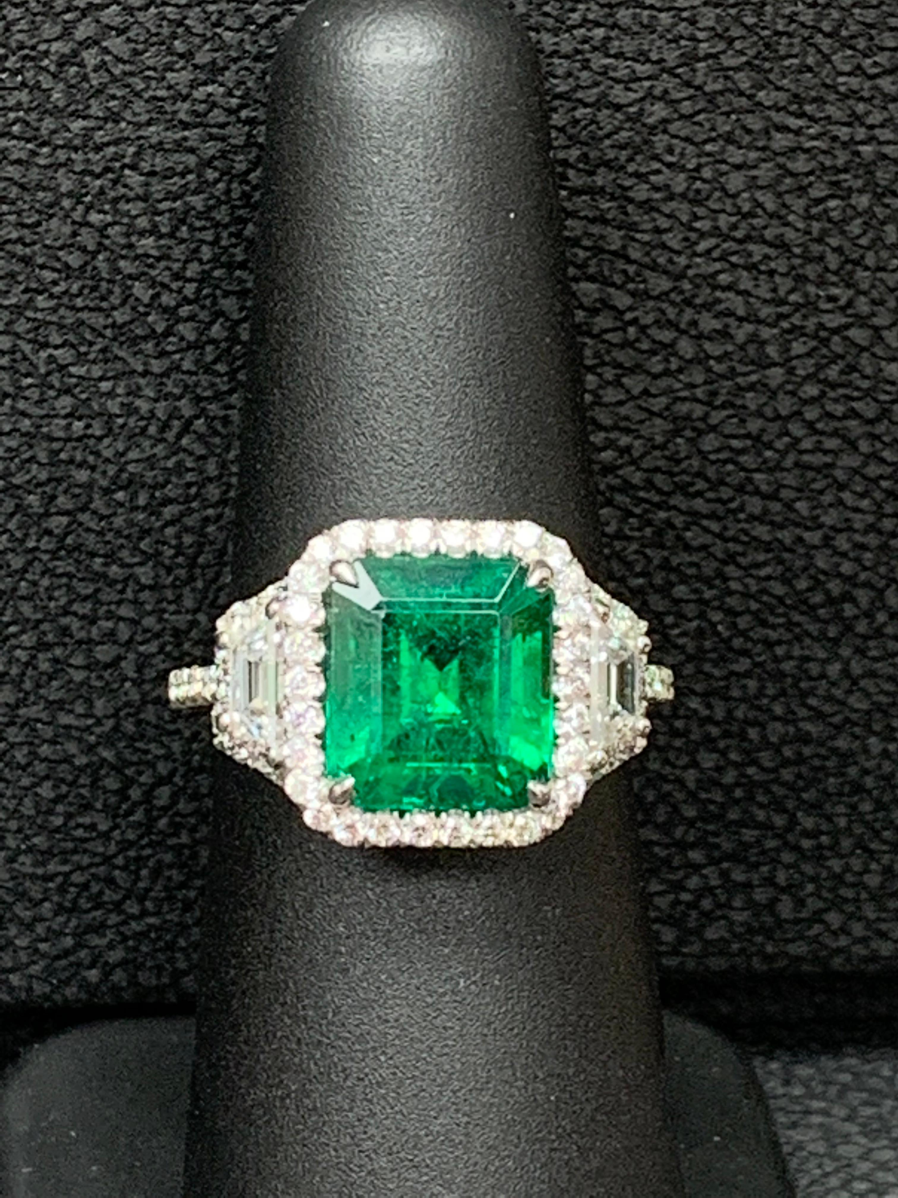 Women's 3.93 Carat Emerald Cut Emerald and Diamond Three-Stone Halo Ring in Platinum For Sale