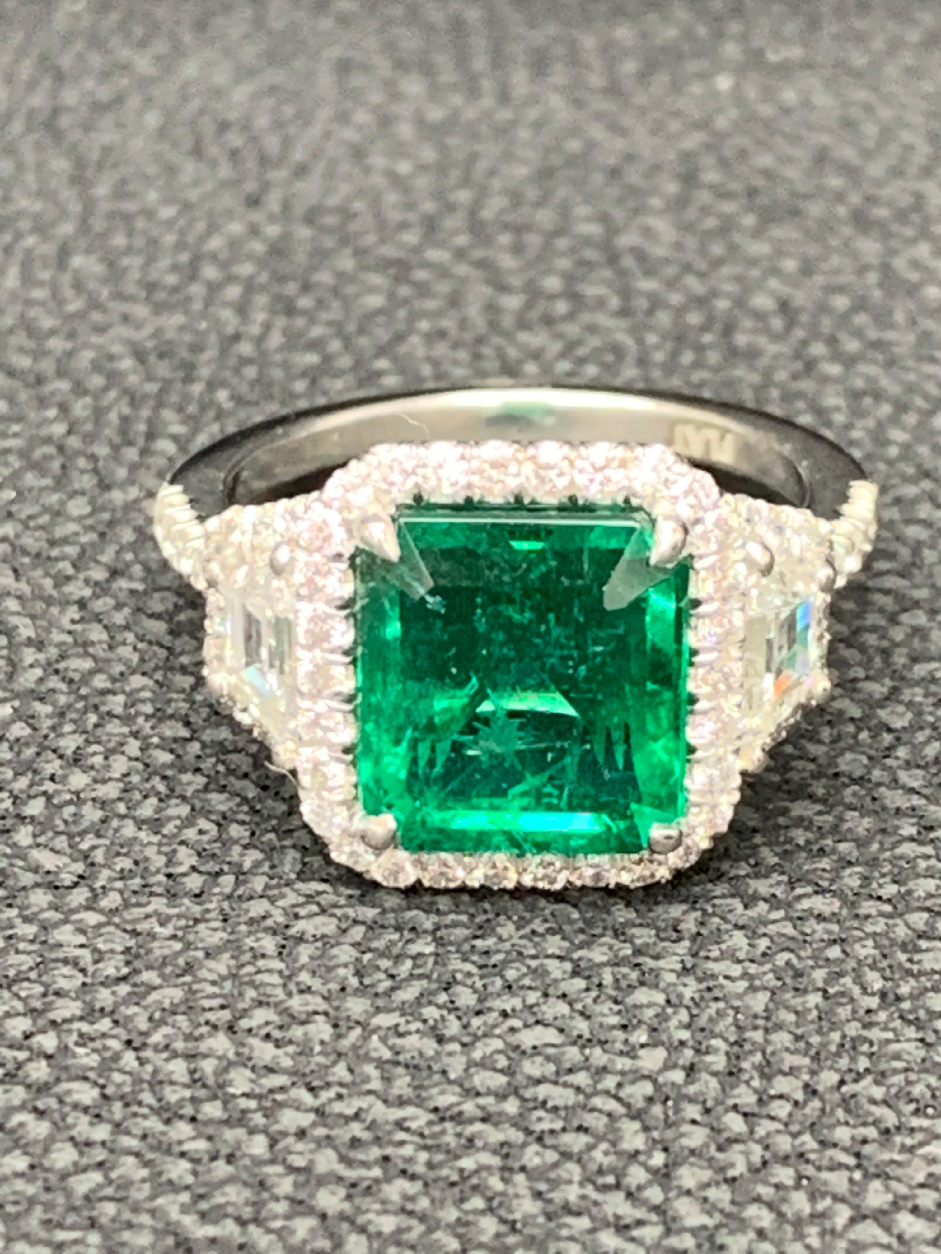 3.93 Carat Emerald Cut Emerald and Diamond Three-Stone Halo Ring in Platinum For Sale 1