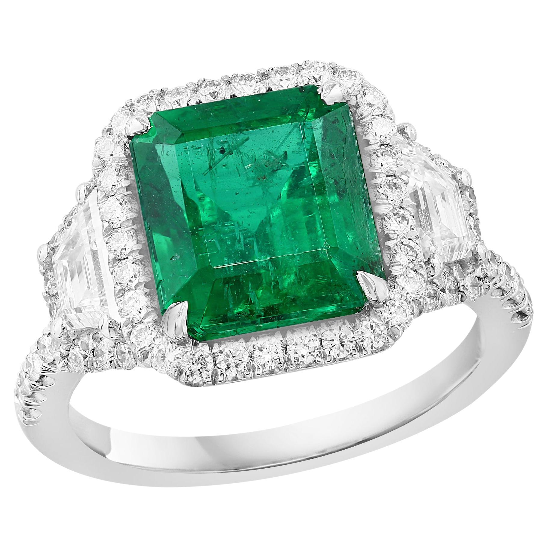 3.93 Carat Emerald Cut Emerald and Diamond Three-Stone Halo Ring in Platinum For Sale