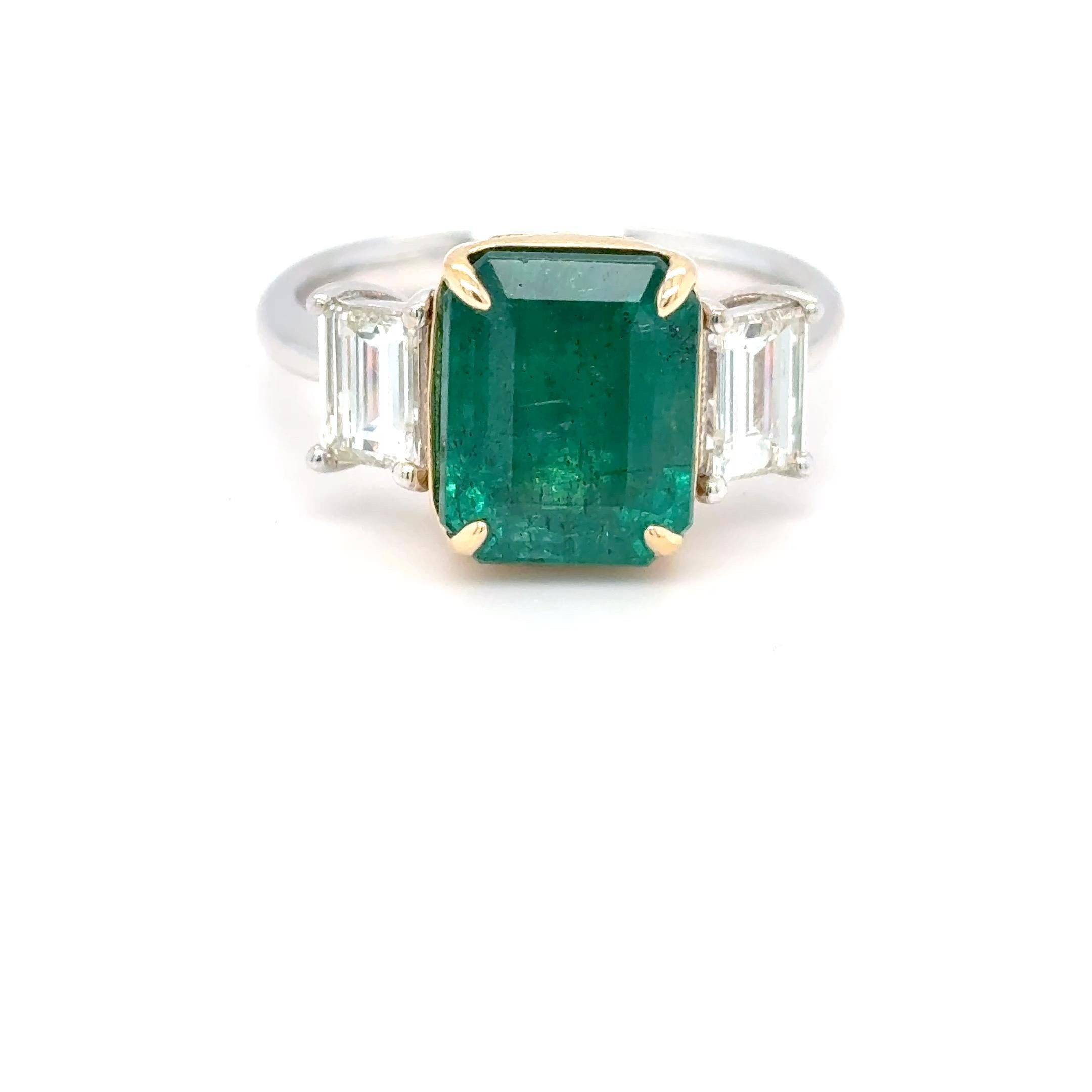 3.93 Carat Emerald & Diamond Ring – Lush Green Elegance

This elegant and timeless ring showcases a stunning 3.93-carat emerald-cut emerald with a rich, lush green color that instantly draws the eye. Flanked east-west by 0.79 carats of emerald-cut