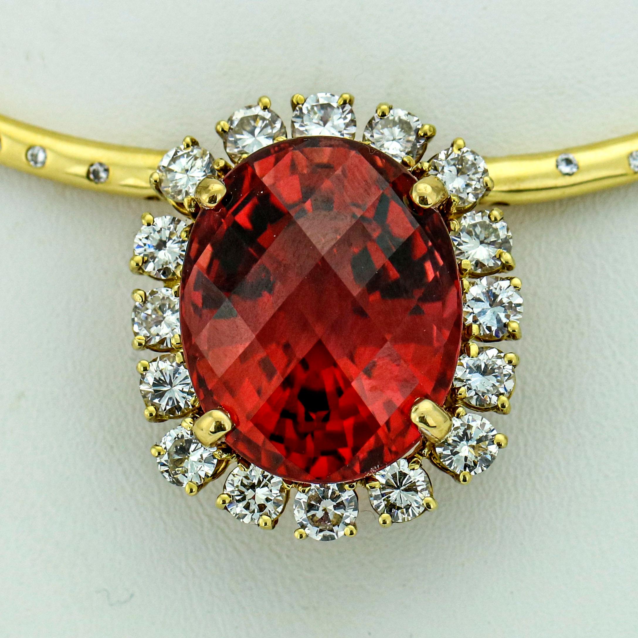 Rubellite Tourmaline and diamond pendant necklace in 18-karat yellow gold. The necklace contains 23 round brilliant cut natural diamonds, and a prong set oval mixed cut tourmaline. It comes with appraisal. The appraisal replacement value