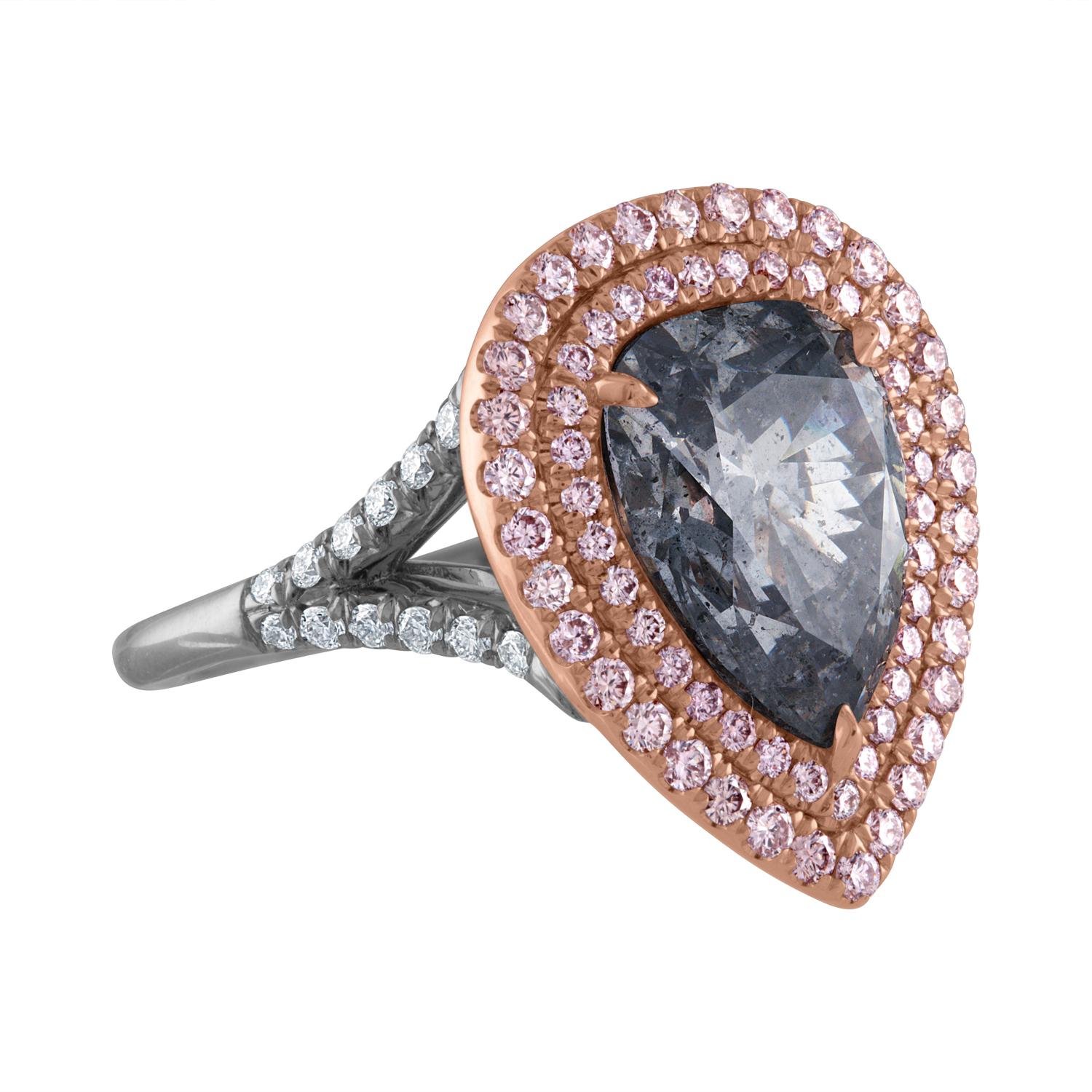 A GIA Certified Diamond as Fancy Light Gray Blue is set in Hand Crafted Platinum & 18K Pink Gold.
Surrounding the Pear Shape Diamond are Two rows of Pink Diamonds. The shank is split and dressed up with White Diamonds on the Split part of the Shank.