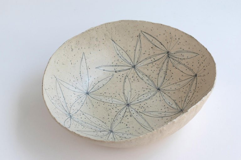 394 hand crafted blossoming stoneware bowl by Helen Prior

A delicate hand-crafted bowl, organic in shape with a torn clay rim in natural speckled stoneware clay.
Part of the Cross Pollination Series- the stylizing and abstraction of elements