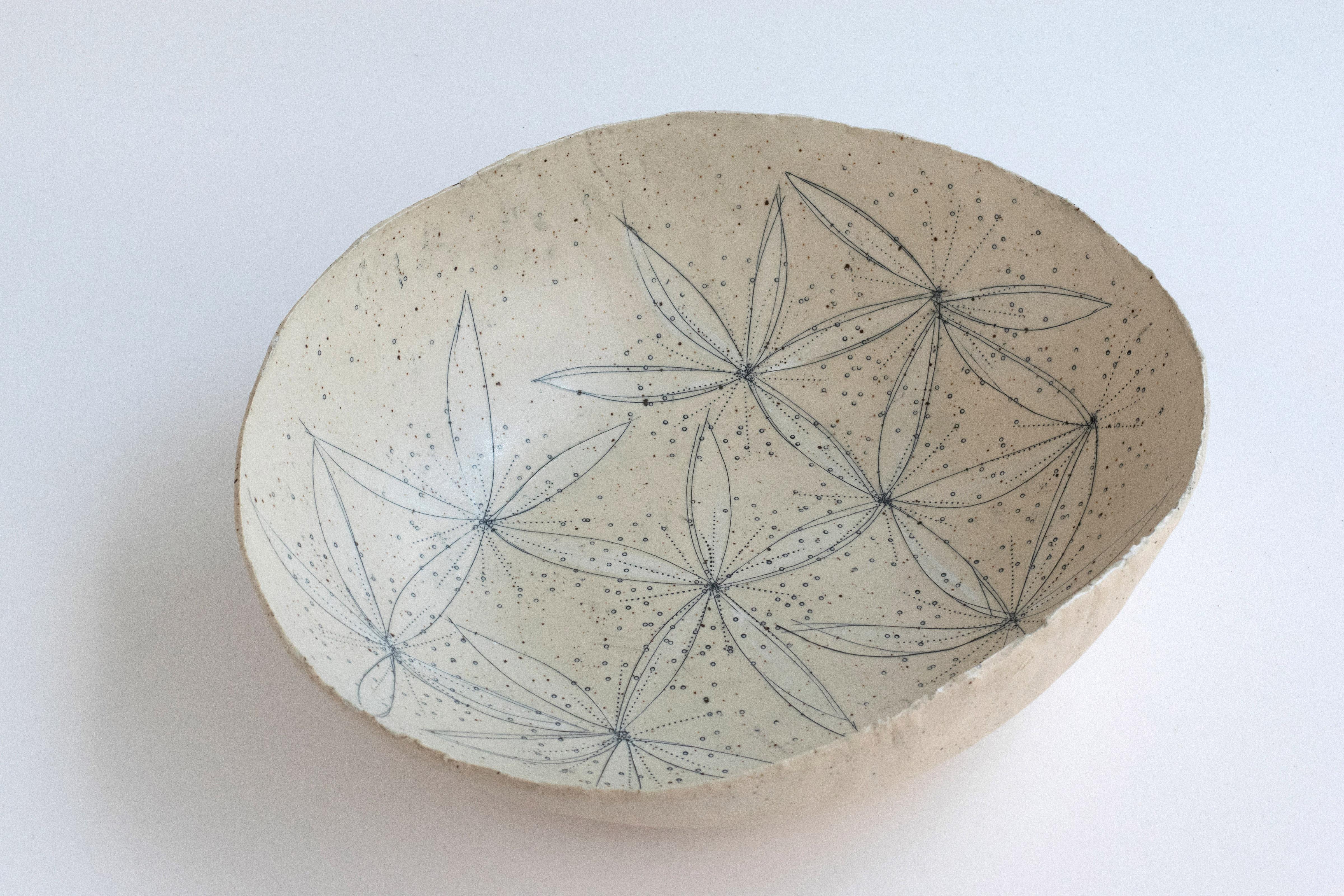 394 hand-crafted blossoming stoneware bowl by Helen Prior

A delicate hand-crafted bowl, organic in shape with a torn clay rim in natural speckled stoneware clay.
Part of the Cross Pollination Series- the stylizing and abstraction of elements from