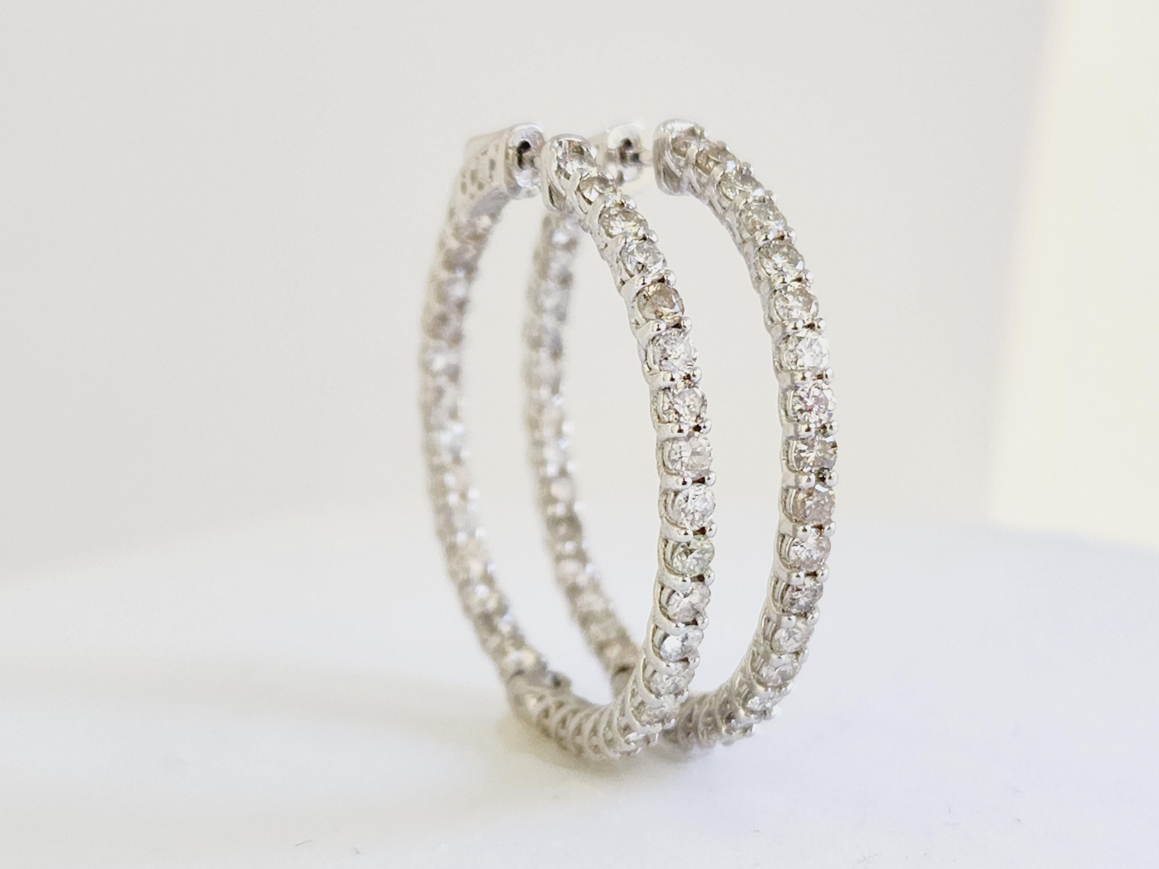 Beautiful pair of natural diamond inside out hoop earrings in 14K white gold. Secures with snap closure for wear. Average Color H, Clarity I, Measures 1.25 diameter. 