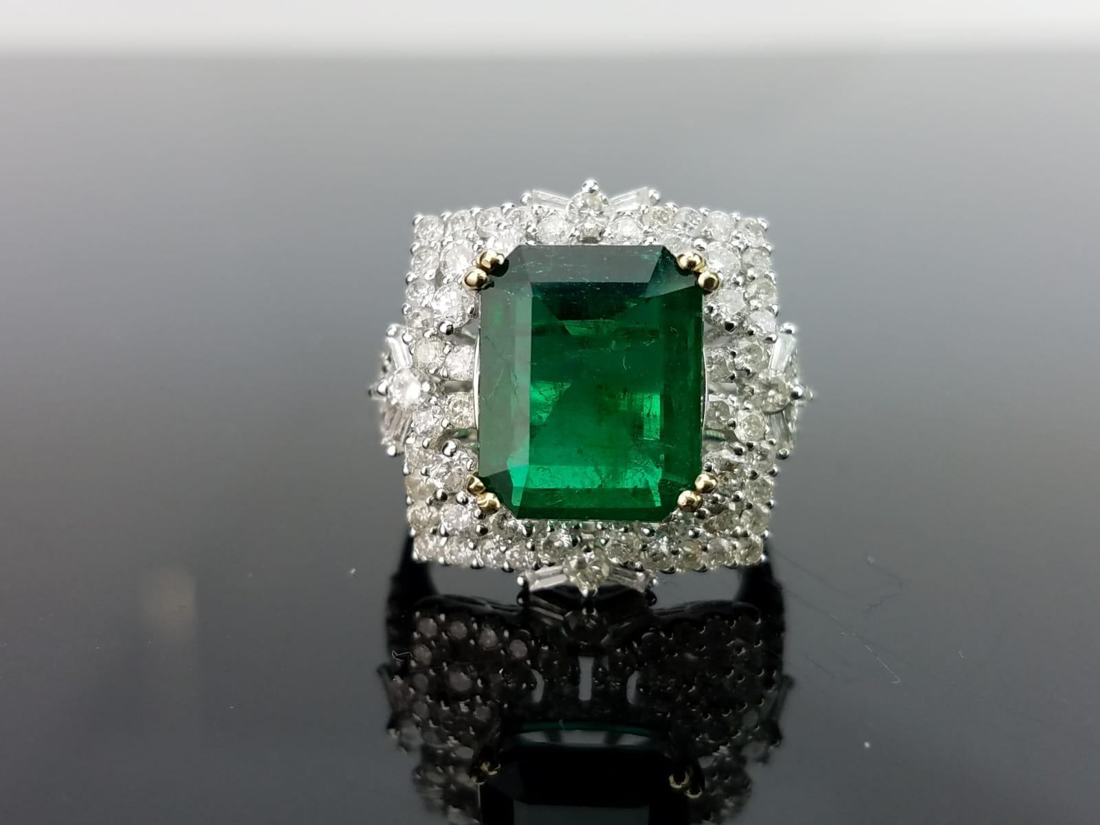 A gorgeous Zambian Emerald centre stone weighing 3.95 carats, with an intense green colour and high lustre; sorrounded by diamonds all set in 18K white gold. 

Material Details:

Stone: Zambian Emerald
Weight: 3.95 carats
Shape: Emerald