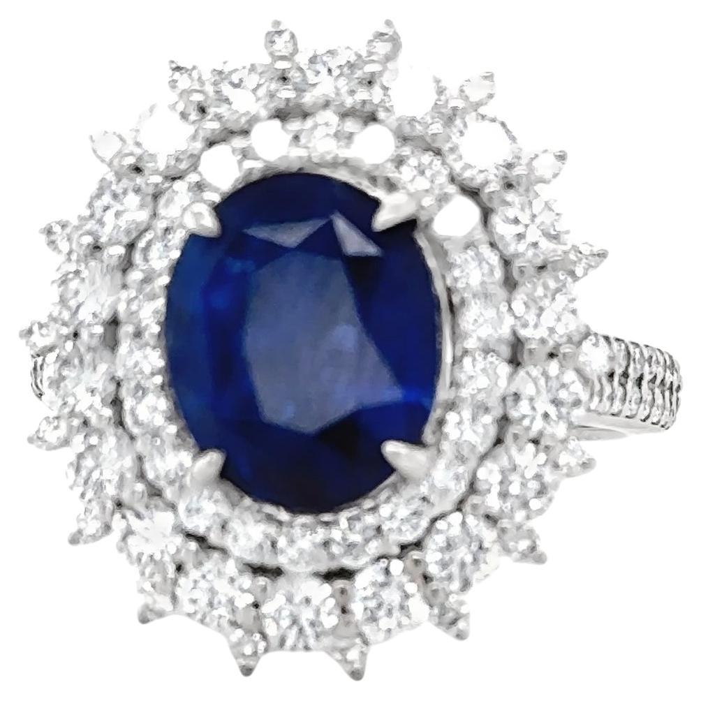 3.95 Carat Royal Blue Oval Sapphire & Diamond Cluster Ring For Sale