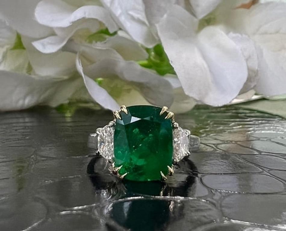 Emerald Weight: 3.95 CTS, Measurements:11.19 x 8.8 mm, Diamond Weight: 0.43 CT, Metal: Platinum/18K Yellow Gold Basket, Ring Size: 7, Shape: Cushion, Color: Green, Hardness: 7.5-8, Birthstone: May