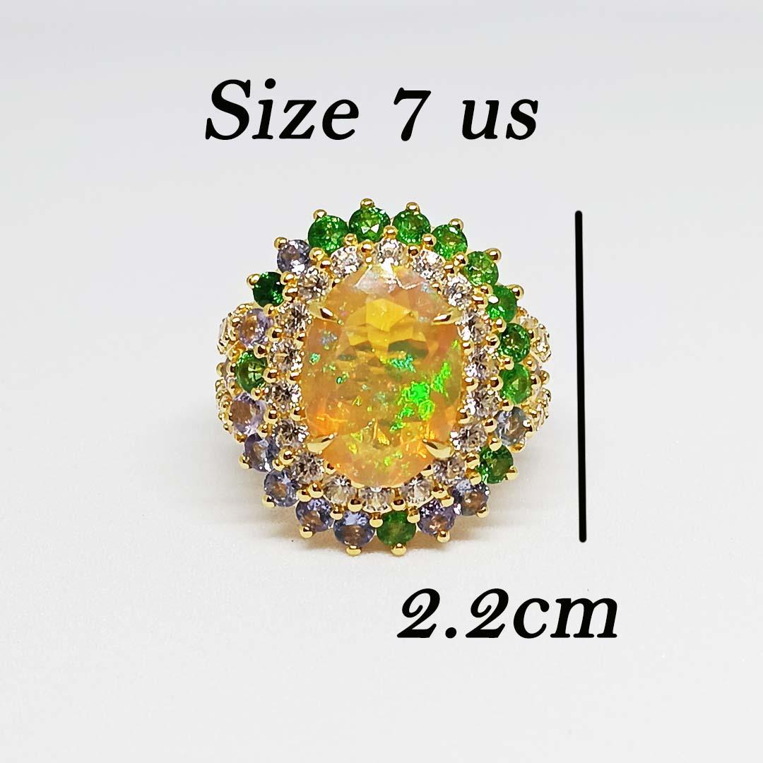 Ethiopian Opal Oval 14x10 mm. 3.95 cts
White Zircon round 2.5 mm. 30 pcs.
Tanzanite round 2.5 mm. 12 pcs.
Tsavosite round 2.5 mm. 12 pcs.
Sterling Silver on 18 K Gold Plated
Ring size 7 us.