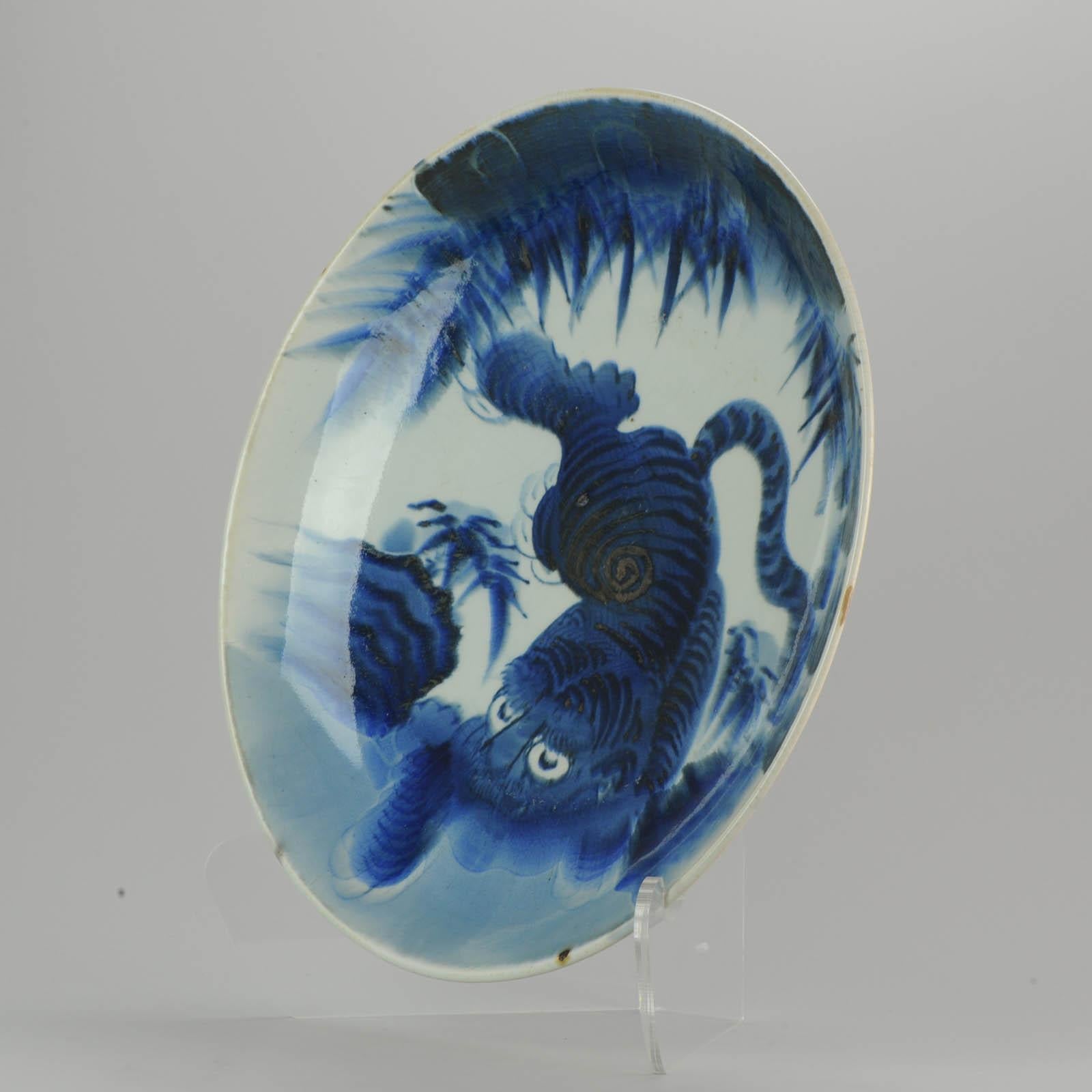 Huge and very nicely painted Japanese charger with blue and white decoration of tiger.
19-8-19-1-2
Condition:
Overall condition: Very good condition, only crackle lines all-over plate. At back only 1 area. Measures: 395 x 64 mm