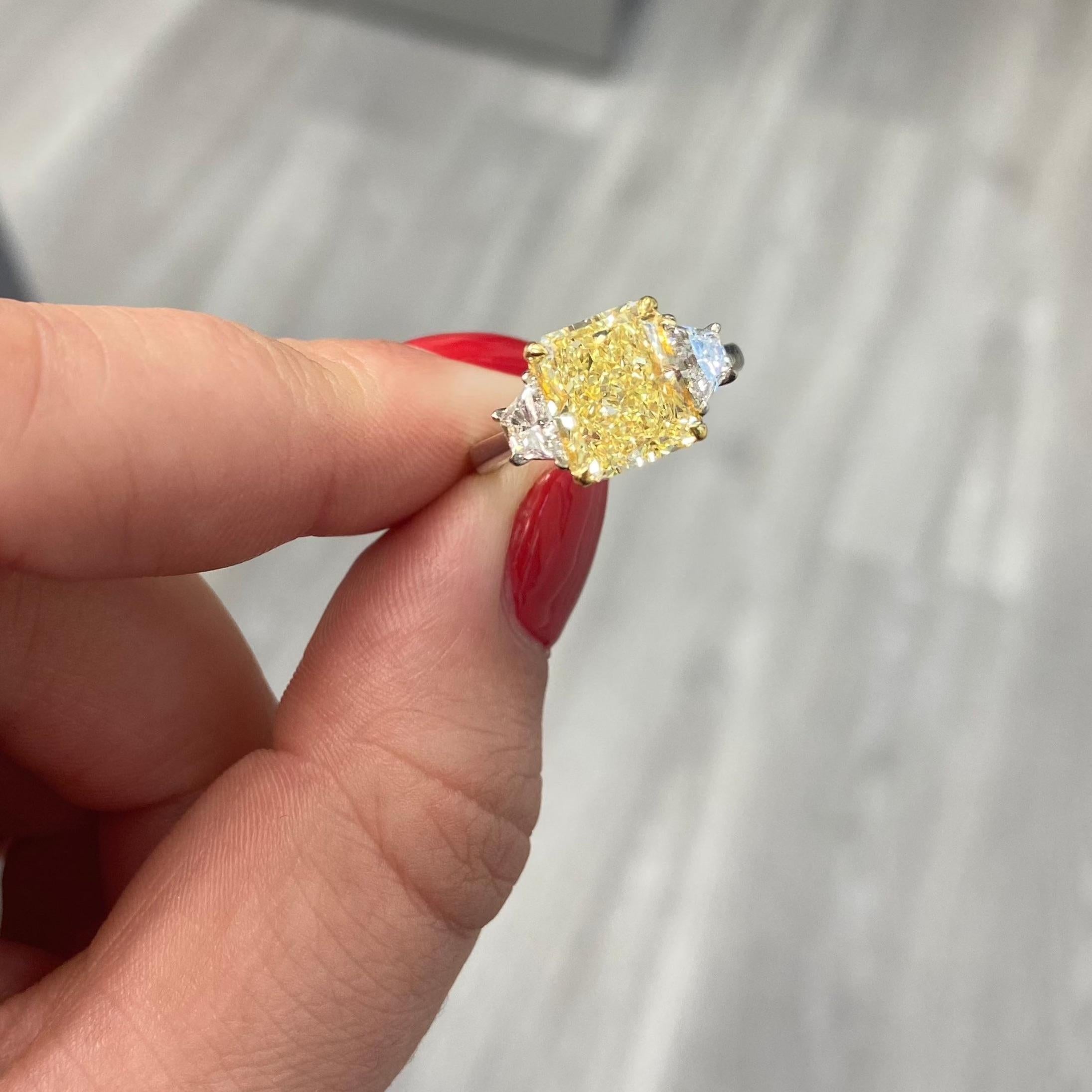 Super crisp and gorgeous diamond. Positively on fire, no dead spots of color, just an extremely beautiful diamond.

3.96 Carat Fancy Yellow
SI1 Clarity
Radiant Cut
Excellent/Very Good cutting
Faint Fluorescence
Handmade in NYC
Set in Platinum &