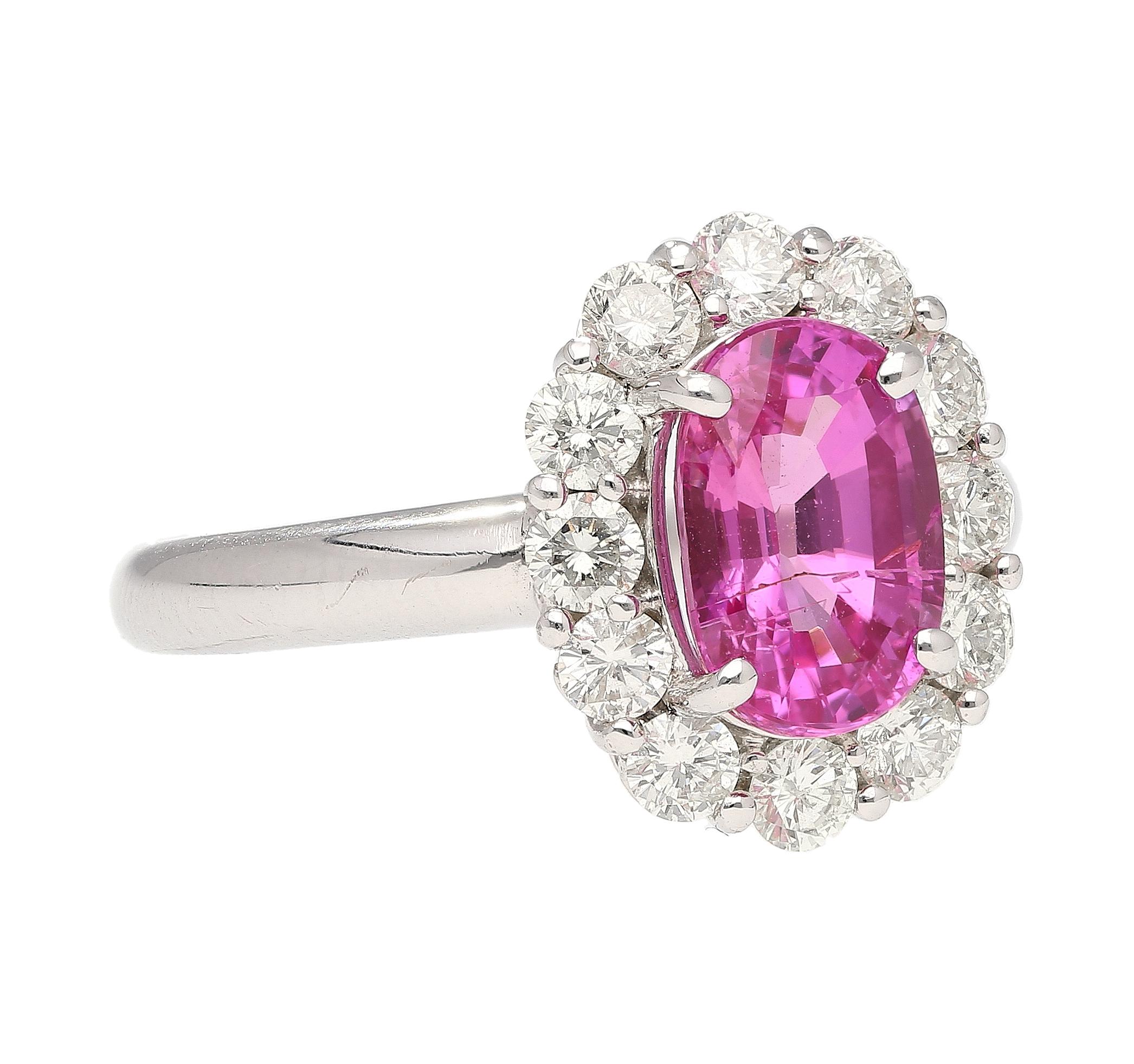 18K White Gold Pink Sapphire Engagement Ring. This exquisite alternative engagement ring is designed to captivate and inspire. Crafted in 18K white gold, this ring showcases a stunning 2.97 carat oval-cut pink sapphire at its center. The pink