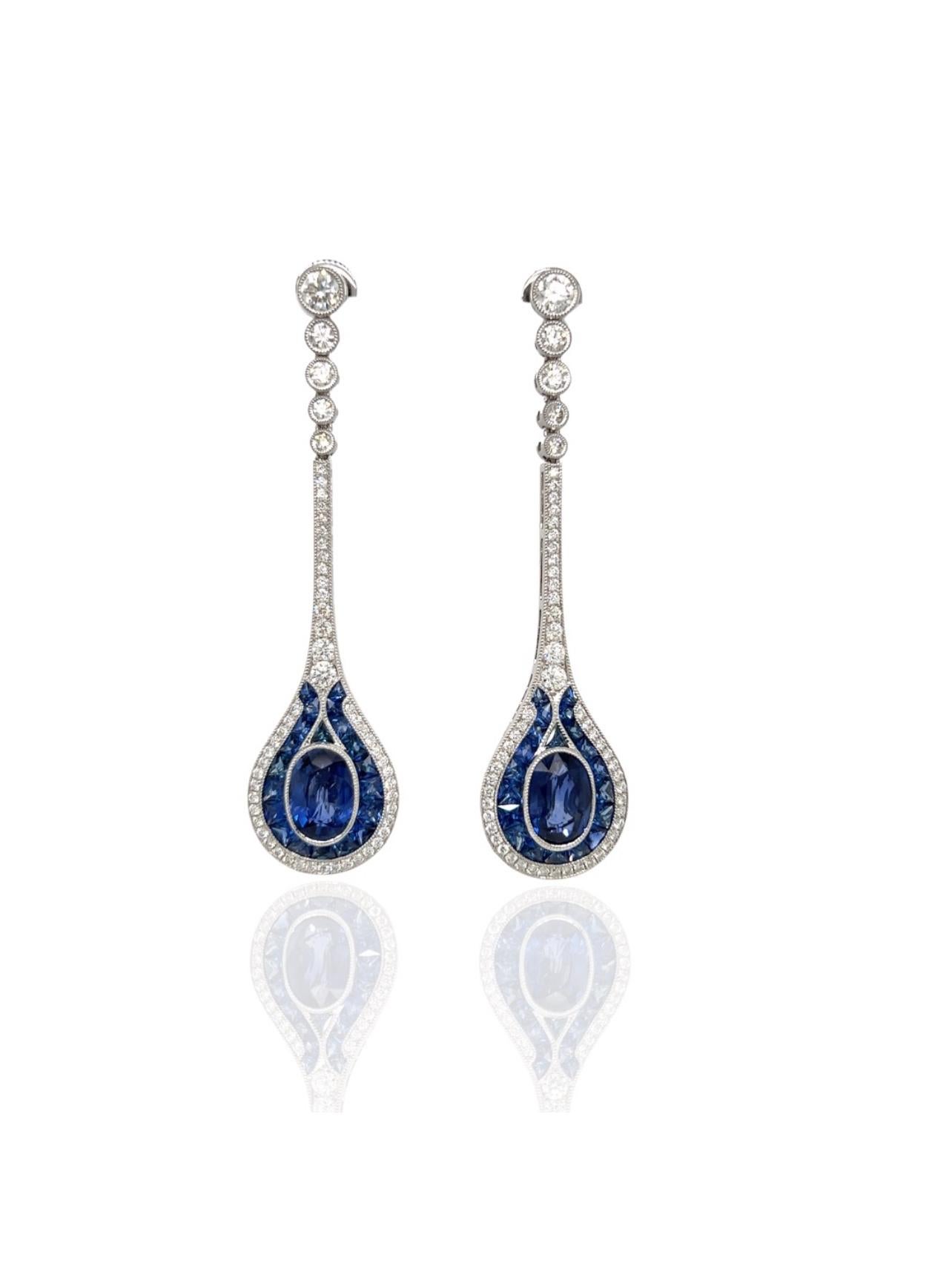 These are magnificient. Beginning with the brilliant round diamonds at the top, expertly set with a milgrain finish to the vibrant blue 3.96 oval fine sapphire, french cut sapphires and the additional diamonds. These dangle earrings are an exquisite